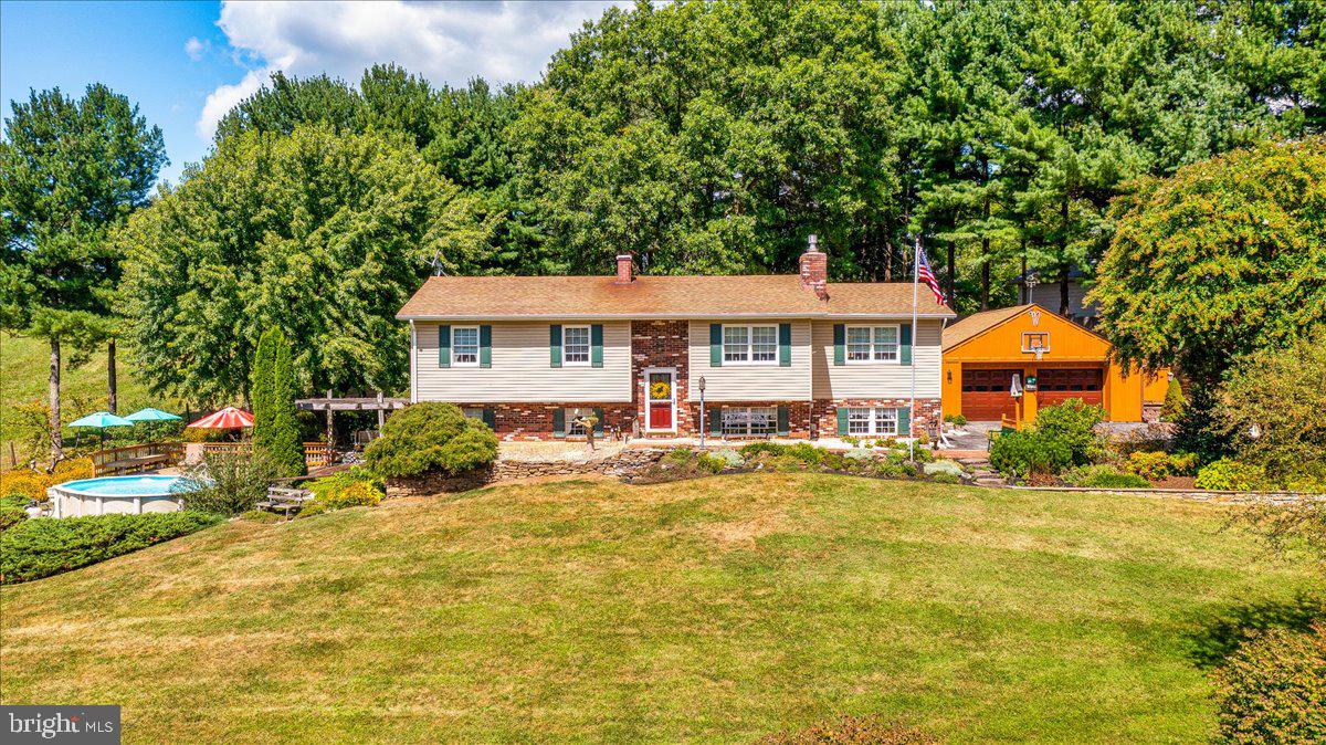 Welcome to 4032 Turkeyfoot Rd — A Place That Feels Like Heaven on Earth!
From the moment you arrive at this stunning property, you’ll understand that feeling! Nestled on 3.25 acres (2.78 acres plus an additional .47-acre parcel), the grounds are a masterpiece of lovingly maintained landscaping and hardscaping, offering beauty and serenity in every direction!
This updated home has been expanded with two thoughtful additions—one creating a bright, airy sitting room off the kitchen with soaring ceilings and a wall of windows, and the other enlarging the living room, also surrounded by windows, making it the true heart of the home! The open-concept main level is surrounded by natural light, creating a perfect setting for entertaining or quiet family gatherings.
The kitchen is both stylish and functional, featuring soapstone countertops, subway tile backsplash, stainless steel appliances, recessed lighting, and a porcelain farmhouse sink—a dream for anyone who loves to cook and connect while entertaining! The spacious living room has vaulted ceilings, custom built-ins, and a propane stove framed by a floor-to-ceiling stone accent wall, making it the ideal place to cozy up as the leaves turn and the seasons change. A generous dining room allows everyone to gather around the table for holidays and special occasions.
Down the hall, the full bath has an updated (2025) walk-in tile shower, skylight, tile floors, and stainless finishes. You will find at the end of the hallway two generously sized bedrooms, both with ceiling fans. A warm and welcoming primary suite with hardwood floors and dual closets completes the main level. The main level also has beautiful hardwood floors that add to the warmth and personality of the home.
The lower level offers incredible versatility! Currently arranged as a large craft and sewing room, it also includes a half bath and laundry. There is a wood stove that helps take the chill out of the air as it gets cooler. There is also a nice-sized storage room with built-in shelving, and office space, also with built-in shelving, allowing anyone to have a private setting to work from home! You can't help but to be drawn outside to the brick patio and pergola, where you can overlook the pool surrounded by composite decking with built-in seating and open fields beyond—an outdoor sanctuary perfect for summer lounging or fall evenings around the firepit!
For hobbyists, woodworkers, or those who simply need extra space, this property delivers! And it delivers big! An oversized two-car garage (26 x 24) with an attached workshop (20 x 11), loft storage, and cooling ceiling fans is just the beginning. The workshop has concrete floors and electricity, perfect for all of your needs if you love working outside. There is also plenty of space for tool storage in this workshop, and behind the workshop, you will find a potting station for all of your gardening needs! The separately deeded parcel includes a beautiful old barn-turned-workshop with concrete floors and electric, offering endless possibilities! The American Flag painted on the barn doors was created by an artistic neighbor!
Whether you’re cooling off in the pool, gathering for a crab feast in the garage, or unwinding to the gentle sounds of the waterfall, crickets, and frogs beneath the stars, this property is a haven that invites you to slow down, breathe deeply, and truly savor life. Come experience 4032 Turkeyfoot Rd for yourself. The moment you step out of the car, you may never want to leave! Schedule your appointment today!