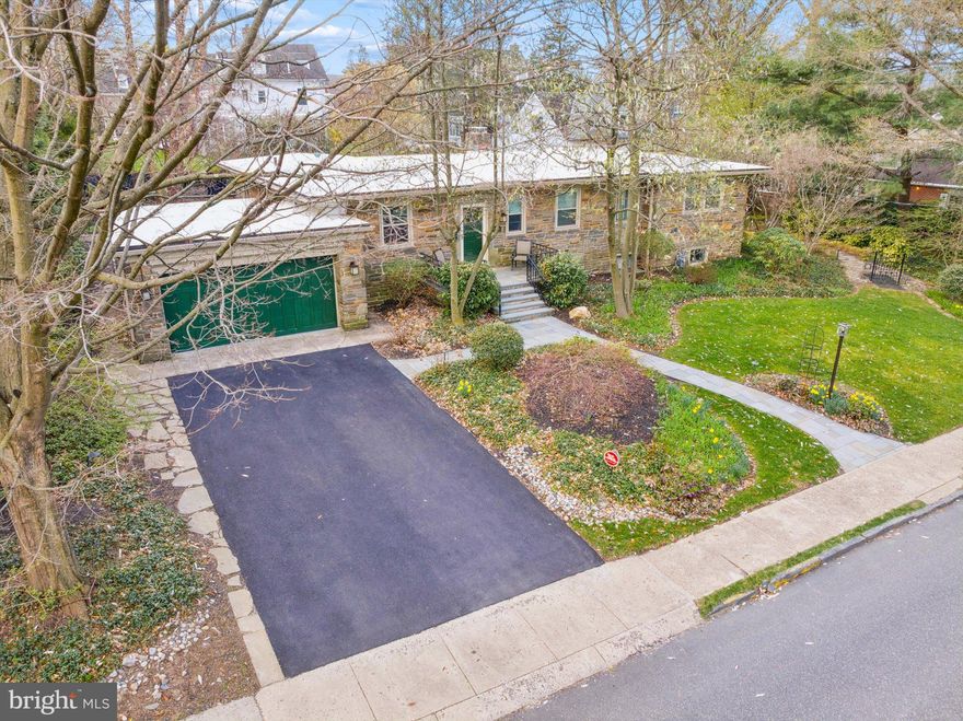 This fabulous all stone mid-century rancher was designed to blend in beautifully with the grander historical homes in this upscale Elkins Park neighborhood.  With over 2700 square feet, this home you can support a lifestyle of  entertainment and, if you wish, intimate days of reading by the fire.   The architect of this home  made a well designed foyer that allows one to have private client  visits to your office  by the front door.  Also in the layout of this house,  all bedrooms have easy access to a full bath .  Besides the lovely parquet flooring in the entry way, the rest of the first floor shines with magnificent  oak  flooring.  Other features that are designed for entertainment are the all season room in glass surround that gives you a view of your inground  pool, the lush back yard full of plant flora and the patios made for picnics. There is a rear entrance to lower level  bedroom, theatre/family room and bath  accessed from a pathway that goes around one side of the house.  This super space  could used as for another generational occupant ! We could go on forever telling you about this house with one floor living  and some open floor space but come see the custom  built home your self