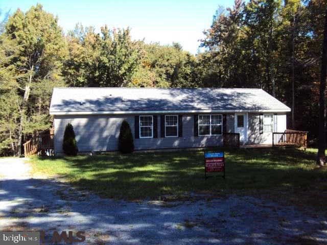 Great home offers a walk around deck, three bedrooms and two full baths. Wood fireplace in the family room. Appliances will stay in this great kitchen. Curtains and blinds are also included. Situated on a partially wood lot that is gently rolling. A must see to appreciate.