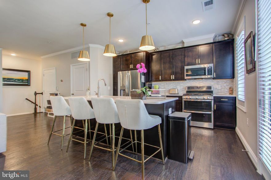 Better than new and available now! Over $50K in upgrades. Your own private elevator inside your home with access to all 4 floors. Premium water view from large deck. Do not miss this opportunity. Beautiful end unit townhouse condo in 55+ Birchwood at Brambleton. This home's location can not be beat. Relax on your low maintenance deck with a view of the clubhouse, common area and sunsets. Larger Bradley model with its own PRIVATE ELEVATOR. 4 levels of spacious living: deck, 1-car garage and upgrades galore. Hardwoods on lower, main and owners suite level. Upgraded stainless steel appliances, kitchen sink, vanities, flooring, fixtures and finishes . High end and custom plantation shutters and wood blinds already installed for you. Upgraded light fixtures with dimmers. Full size, front load washer and dryer on owners bedroom level. Come see this fantastic home in a community that has it all for 55+ active living. Remarkable club house and amenities with indoor/outdoor pools, modern meeting/gathering spaces and recreation areas.