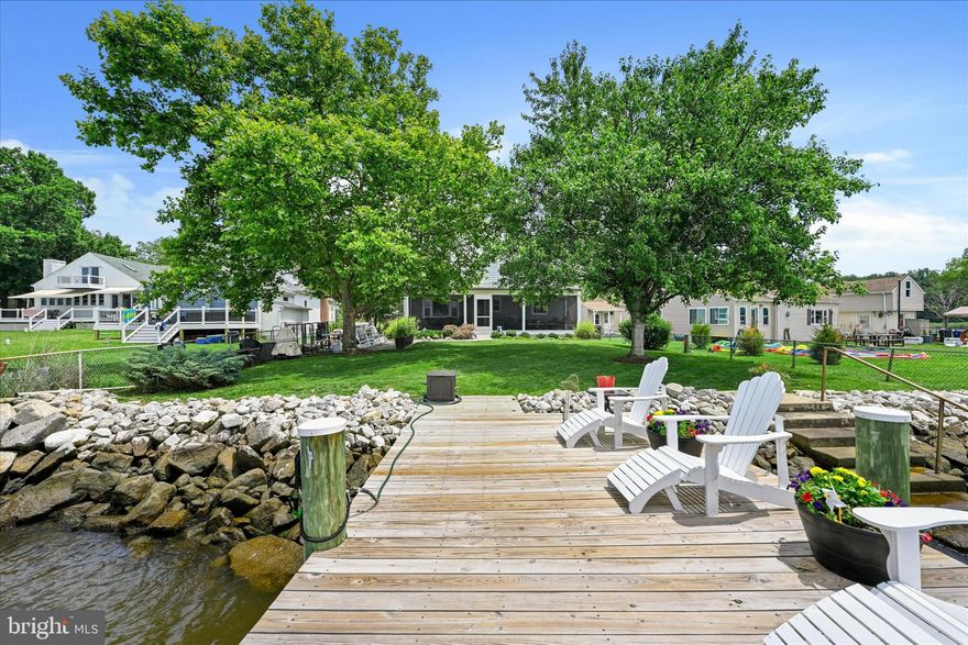 THE WATERFRONT PROPERTY YOU'VE BEEN WAITING FOR!!!!  This fantastic waterfront home offers a clear open water view of the Key Bridge and the distant lights of Baltimore Harbor.  Perfectly located at the mouth of Rock Creek, surrounded by Ft Smallwood Park and Weinberg Park to the north and south and only minutes from Compass Point’s two 18 hole championship golf courses.  This waterfront retreat features a gourmet kitchen with stainless appliances,  as well as a first floor primary bedroom with updated full bath with free standing tub. The living room with fireplace and breakfast room both have water views looking through the screened patio with ample space to entertain.  Upstairs there are two additional bedrooms and a second full bath.  There is a beautifully redone pier with deck seating and a boat lift.  Recent Updates include  roof, HVAC ductwork, pier and baths. Plenty of parking with an attached two car garage and carport. Community ramp and open space one door away. This is truly one of the best locations on the Bay!! This Fall you could be enjoying the Bay Life, watching the sunset over the water, and dining on Blue Crabs and Striped Bass caught off of your own pier. Easy access to Annapolis and DC.  Opportunity Is Knocking.