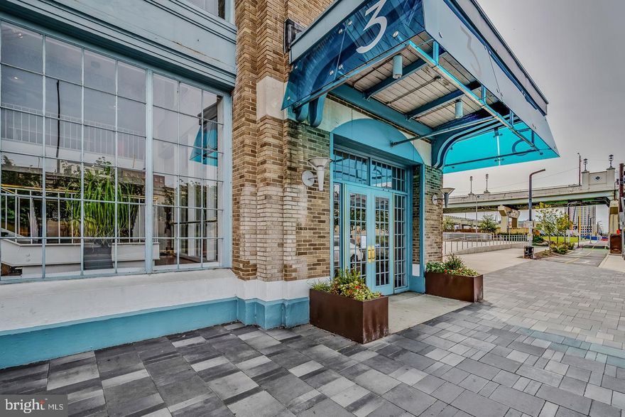 Experience the perfect blend of modern living, waterfront tranquility, and historic Philadelphia charm at Pier 3 Condominiums. This beautifully remodeled bi-level 1-bedroom, 1.5-bath residence is fully move-in ready and offers a sophisticated marina-front lifestyle enhanced by luxury amenities and thoughtful upgrades. Originally built as a working shipping pier and later transformed into one of Philadelphia’s first premier waterfront condominium communities, Pier 3 pairs its industrial character with resort-style living to create a truly unique experience. Upon entering, you are welcomed into an inviting foyer anchored by a dramatic wide architectural spiral staircase—both a functional feature and a striking design statement. The open, flexible floor plan is finished with newly installed flooring that sets a warm, contemporary tone throughout. The custom-designed kitchen features a stylish open bar that flows seamlessly into the living and dining areas, creating an ideal space for gatherings or everyday comfort. Two sleek, modern bathrooms and an in-unit washer and dryer provide exceptional convenience, while soaring ceilings with massive exposed steel beams highlight the home’s industrial heritage. Large windows fill the space with natural light, and a private deck overlooking the serene courtyard offers a peaceful retreat. Upstairs, the spacious bedroom suite welcomes abundant sunlight and features a generous sliding glass door that opens directly onto the upper pier deck—your second private outdoor space—along with excellent closet storage and an additional large hallway closet. The home has been enhanced with numerous high-quality upgrades, including a high-performance HVAC system installed in April 2024, a newly constructed upper deck, a newer refrigerator, a hot water tank installed in October 2024, complete interior repainting and new flooring, and an updated washer and dryer. Additional features include thoughtfully selected lighting, a dedicated garage parking space, and the security of a 24-hour concierge. Life at Pier 3 offers resort-style amenities designed for relaxation, wellness, and convenience, including a heated indoor swimming pool, a well-equipped fitness center, secure garage parking with EV charging stations, elevators and multiple mezzanine levels with sweeping Delaware River and Ben Franklin Bridge views, and a pet-friendly environment (with weight limits). The monthly condo fee covers snow removal, trash collection, exterior building maintenance, and all amenities, making this the ideal lock-and-leave lifestyle along the scenic Delaware River Waterfront, Pier 3 places you at the heart of one of Philadelphia’s most vibrant and continually evolving neighborhoods. Just steps away are Blue Cross R Winterfest and Summerfest, where you can enjoy ice skating in the winter and roller skating, rides, and seasonal attractions in the summer, along with front-row views of holiday fireworks throughout the year. A short 10-minute walk brings you to Spruce Street Harbor Park’s floating barges, hammocks, food vendors, and summer programming, while Cherry Street Pier and Race Street Pier offer art installations, riverfront seating, live events, and cultural experiences. Direct access to the waterfront trail and proximity to the expanding Northbank community elevate the outdoor lifestyle even further. You are also within walking distance of Penn’s Landing festivals, seasonal events, Rivers Casino, Old City’s renowned dining and shopping district, and countless waterfront attractions. Quick access to major highways, bridges, public transportation, the airport, Center City, and Fishtown ensures effortless commuting and city exploration. Indulge in the pinnacle of luxury waterfront living at Pier 3 Condominiums—timeless industrial architecture, and natural beauty come together to create an exceptional home.