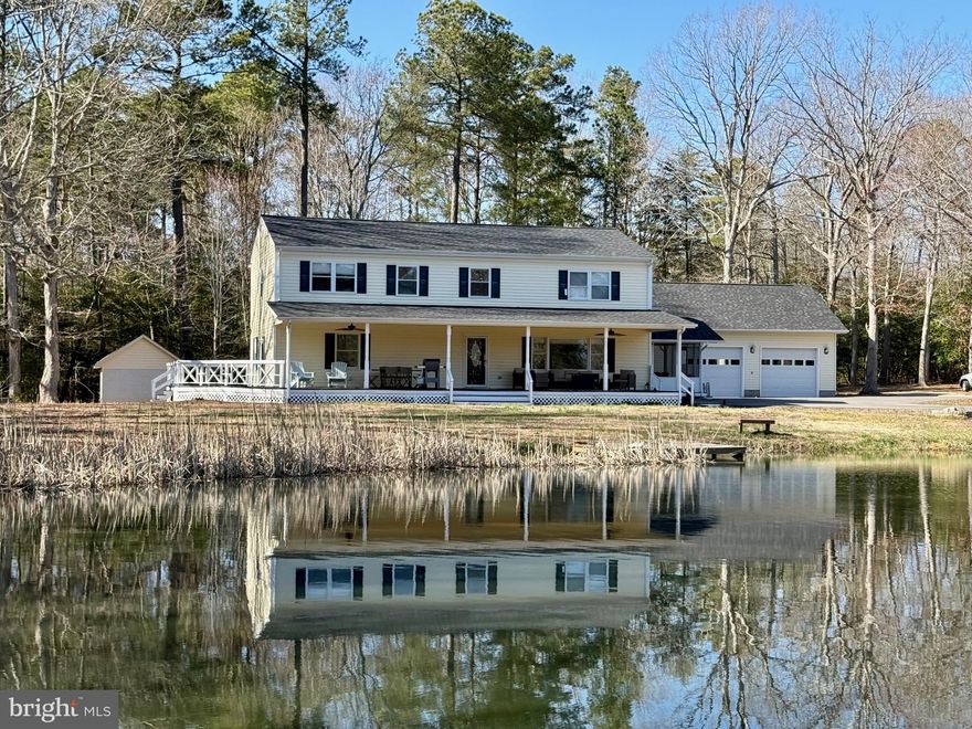 Secluded and serene, this charming farmhouse sits on 3.4 acres with a picturesque pond. Renovated in 2019, updates include the interior, roof, HVAC, and siding. The open floor plan seamlessly connects the kitchen, living, and dining areas. Relax on the screened porch or covered deck while enjoying the views. The main level offers a bedroom and full bath, plus a half bath and an office with access to the side deck. Upstairs, you'll find four spacious bedrooms. The oversized two-car garage features finished barnwood walls, and a circular driveway provides ample parking.