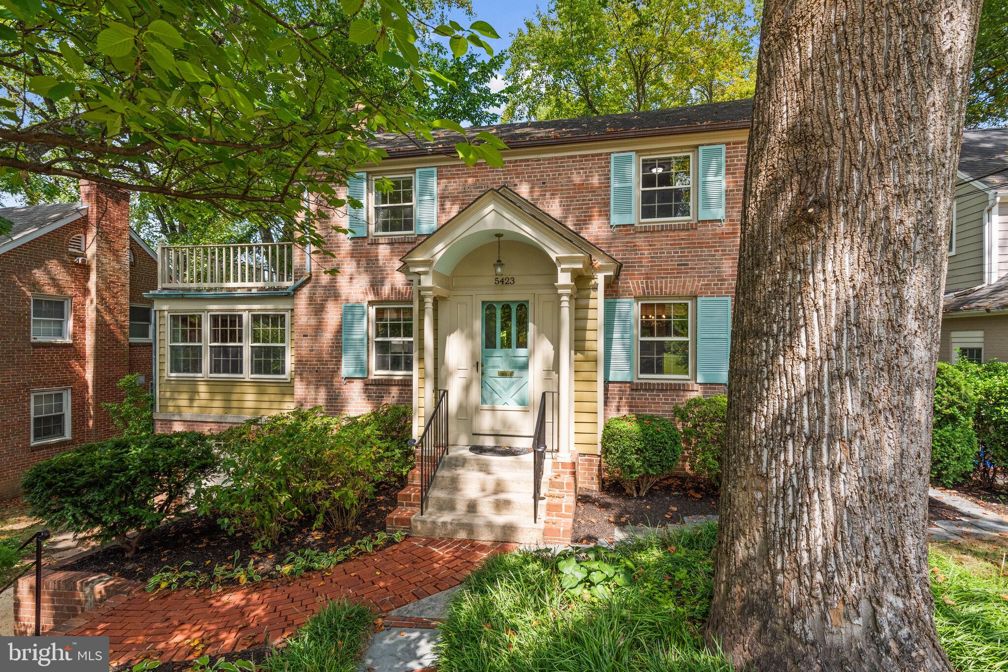 New Price! Come take a look! Vibrant and Inviting Battery Park Hills Home!  This timeless 1948 brick Colonial has been beautifully expanded and updated over the years and offers fabulous indoor/outdoor living with its wrap-around deck and picturesque yard. 5423 Harwood Road  has four bedrooms, three and a half bathrooms on three levels, with a total of 4,024 interior square feet. The main floor includes a foyer, formal dining room, kitchen with separate breakfast room, family room opening to the deck, living room with wood burning fireplace, den/sunroom and half bath. Skylights and a second staircase to the upper level add light and charm. The upper level provides three good-size bedrooms and two updated bathrooms (including a spacious primary suite with walk-in closet, bathroom with separate tub and shower, and walk-out deck), as well as a laundry room. The partially-finished lower level offers plenty of space, including a fourth bedroom opportunity, third full bathroom, storage room, and utility room. The enchanting wrap-around deck along the back of the home provides expansive outdoor space for dining, entertaining, and enjoying the peaceful canopy of trees. Harwood Road is a quiet cul de sac in the middle of downtown Bethesda and the exquisitely landscaped lot is 8,081 square foot (0.19 acre).
The property is located within the popular Battery Park Hills Neighborhood and the Walt Whitman High School District. Walk to Metro and all the shops and restaurants in downtown Bethesda! Open Sunday 2-4!