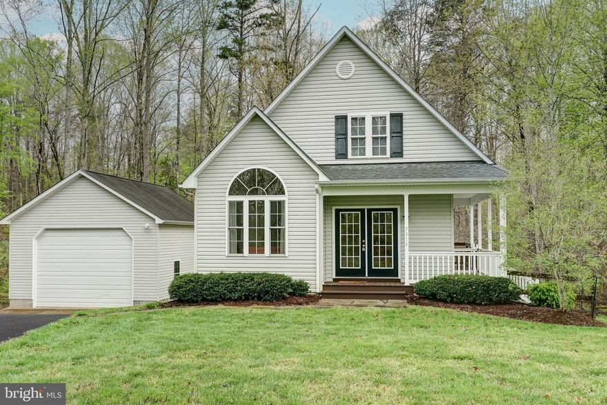 Welcome to your perfect lakefront escape on the public side of Lake Anna, VA. This charming A-frame cottage offers the ideal setting for relaxing getaways or full-time lake living. Featuring 1,715 finished square feet, the home includes 3 bedrooms, 2 full baths, plus a versatile bunk room in the finished basement. The main level showcases an open floor plan with hardwood flooring, an eat-in kitchen, and a vaulted family room filled with natural light. A bedroom, full bath, and mudroom complete the main level. Upstairs, you'll find two additional bedrooms and a full bath. Downstairs, the finished basement offers extra space to spread out, with a rec/family room, bunk room, and laundry area. Step outside to a covered wrap-around porch and spacious rear deck—ideal for BBQs and outdoor entertaining. Gather around the fire pit on cool evenings or head down the wooded path by foot or ATV to your private waterfront oasis. Enjoy 30 feet of bulkheaded shoreline and your own covered boat dock equipped with a generator-powered lift. Whether you're watching sunsets with a cocktail in hand, taking a boat ride or a peaceful paddle, this is lake life at its best. Additional features include a paved driveway, an 8x10 storage shed, and a 24x30 detached garage with high bay doors—perfect for storing your boat, lake toys, or vehicles. Recent upgrades include a new water heater (2022) and a new Trane HVAC system for the upper level (August 2024).