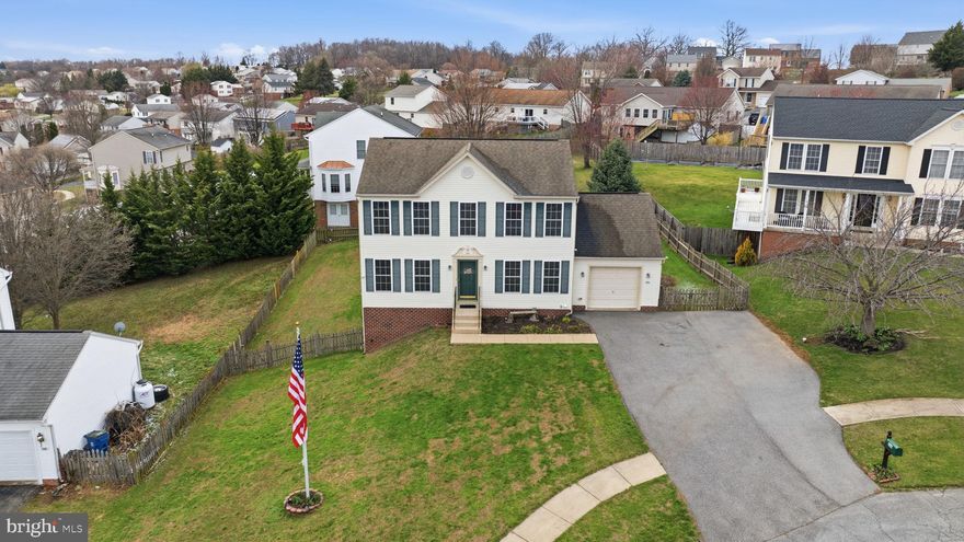 Welcome to 104 Drew Circle, where beautiful views and a thoughtfully designed layout come together to create a place that truly feels like home. Step out the front door and take in the peaceful ridgeline views of Catoctin Mountain stretching across the horizon. From this same vantage point you can also see all three of the Smithsburg schools, a unique feature that reflects the home’s elevated setting and open views. After a passing rain shower, the scenery becomes even more special—rainbows often stretch across the mountains, and in the fall the changing mountain foliage creates a breathtaking backdrop, making it easy to appreciate just how beautiful all four seasons can be from this location. This well-maintained Colonial, built in 2004 and set on a 0.23-acre lot, offers 3 bedrooms and 2.5 bathrooms and over 2,000 square feet of living space across all levels, giving the home plenty of room to spread out and enjoy. From the moment you arrive, the property welcomes you with classic curb appeal, featuring an oversized one-car garage, an extended driveway for additional parking, and a front yard flagpole proudly flying the American flag, giving the home a warm and timeless feel. Step inside and you’ll find a spacious main level where the den and kitchen naturally serve as the heart of the home—a place where meals are prepared, conversations happen, and memories are made. The kitchen’s L-shaped counter layout offers plenty of workspace and room to gather, making it just as functional for everyday living as it is for hosting friends and family. The first floor also includes a versatile additional room that can easily serve as a dining room, home office, reading space, or extra sitting area depending on how you choose to use it.Upstairs, you’ll find two generously sized secondary bedrooms along with a full hallway bathroom, offering comfortable space for family, guests, or hobbies. One of the bedrooms even includes a laundry chute that conveniently drops to the finished portion of the basement, a thoughtful detail that adds everyday practicality. The primary suite provides a relaxing place to unwind at the end of the day, complete with a walk-in closet and private en-suite bathroom featuring a double vanity, a large whirlpool soaking tub, and a separate walk-in shower. The partially finished basement adds even more flexibility, offering additional space that could easily serve as a recreation room, workout area, or second living space. With its full-size window and walk-out door to the side yard, the layout could also allow for the addition of a future bedroom with the proper modifications. The finished portion of the basement is where the laundry chute arrives, while the unfinished section houses the washer and dryer hookups, along with several thoughtful upgrades including a radon mitigation system with a recently replaced fan, a reverse osmosis water system supplying the kitchen sink and refrigerator ice maker, and a whole-home water filtration system. Step outside and you’ll discover a spacious fenced backyard that offers plenty of room to relax, play, garden, or entertain. Whether it’s a quiet morning with coffee, an afternoon with pets running in the yard, or an evening gathering with friends, the outdoor space provides endless possibilities. The yard is anchored by a reinforced Trex deck, built for durability and low maintenance, creating the perfect spot for cookouts, summer evenings, or simply enjoying the fresh air. The deck also features removable sun sails that can be installed during the warmer months, helping keep the deck surface cooler and making the space even more enjoyable on sunny days. The backyard also includes a storage shed, providing convenient space for lawn equipment, tools, or additional outdoor storage. With its scenic setting and easy access to major commuter routes including I-70 and I-81, this home offers the perfect balance of peaceful living and everyday convenience.