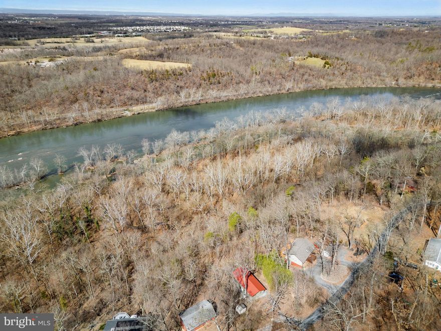 Escape to this enchanting cabin nestled amidst the picturesque beauty of the Shenandoah River and majestic mountain vistas! With an additional lot boasting 80 feet of prime river frontage, this retreat offers unparalleled tranquility and outdoor adventure. Featuring cathedral ceilings, a cozy wood stove, a new metal roof, and double-decker 20 x 12 screened-in porches, it embodies the essence of rustic charm and relaxation. Nestled within Blue Ridge Acres, community members can gain access to the clubhouse, pool, and tot lot, enhancing the sense of community and recreational opportunities. For those craving aquatic exploration, canoes and a kayak are available for purchase. Additionally, the option to acquire all furnishings transforms this haven into a seamless, turnkey opportunity. Notably, flood insurance is not required for the upper lot housing the cabin, providing savings and peace of mind. Explore, unwind, and make this enchanting retreat your own. Lower lot is in flood zone. HIGHEST & BEST OFFERS ARE DUE BY MONDAY 3/18 at Noon.