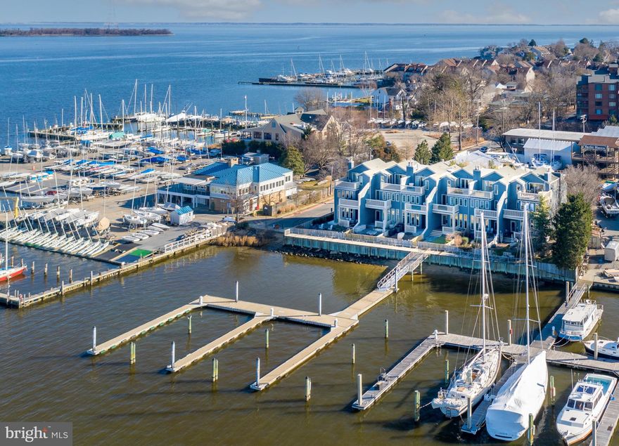 Premiere Annapolis waterfront townhome on Spa Creek offering magnificent water views of the Severn River, U.S. Naval Academy, the city skyline and harbor. Enjoy waterfront living with a 50' deep water slip (10 ft MLW) steps from your back door. Stunning Million Dollar interior renovation completed in 2020 with the finest of materials and finishes including wide plank oak floors, Waterworks hardware, signature lighting, and designer paint colors. Exquisite, Modern white kitchen boasts honed marble counters, expansive island, top of the line appliances including a La Cornue French range, floor to ceiling transom windows and tons of natural light. Impressive primary suite with amazing water views, custom designed, all white luxe bathroom, custom walk-in closet, and private waterside balcony. Upper level family room with Lepage Retractable Door System to deck perched above the water for optimal views of fireworks, the boat parade and Blue Angel flyovers with additional bedroom suite that can sleep a family of four.  Waterside deck and courtyard with plantings, slate walkway and outdoor subtle lighting. 1-car garage and parking for 2 additional cars. Located in Harbour Place, an enclave of 6 luxury townhomes in a coveted walk-to town location in Eastport!