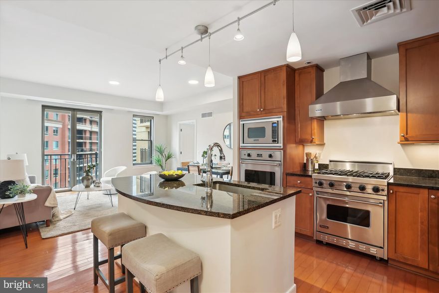 Discover the allure of urban living in the heart of Bethesda with this rarely available gem – a 2-bedroom, 2-bathroom condo nestled within the prestigious Lionsgate Condominiums. Step into a world of elegance where every corner whispers comfort and sophistication. 
<br/><br/>
As you enter, be greeted by the seamless flow of the open layout, enhanced with exquisite hardwood flooring that adds warmth to the space. Prepare culinary delights in the gourmet island kitchen, where beautiful wood cabinetry meets stainless steel Viking ovens and sleek granite countertops, elevating every cooking experience.
<br/><br/>
The bedrooms, strategically positioned on opposite ends of the unit, offer a sense of privacy and tranquility. The owner's suite features a customized walk-in closet outfitted with built-in organization for effortless storage solutions. Pamper yourself in the primary bathroom, complete with double sinks, a granite countertop, and natural stone flooring, creating a spa-like retreat right at home. 
<br/><br/>
The second bedroom is a haven of natural light, courtesy of its wall-to-wall bay windows, casting a gentle glow throughout. Need extra space for guests or a home office? Look no further than the versatile Murphy bed, seamlessly blending functionality with style.
<br/><br/>
Outside your doorstep lies the vibrant pulse of downtown Bethesda, with its array of dining, shopping, and entertainment options, ensuring there's never a dull moment. And when you seek respite, return to the tranquility of Lionsgate, where luxury and convenience converge, with a rooftop deck,  fitness center, library, and party room with complimentary wi-fi and basic cable.
<br/><br/>
Don't miss your chance to experience the epitome of urban living. Schedule your appointment today and make this condo your new home. Time is of the essence – seize this opportunity before it slips away.