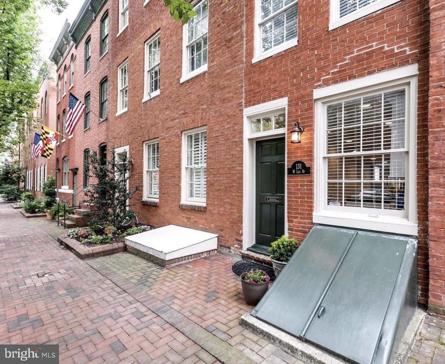 Tucked along one of Otterbein’s prettiest tree-lined streets, this light-filled brick rowhome beautifully blends classic charm with modern comfort. Fully renovated about four years ago, it’s the kind of place that instantly feels like home — welcoming, stylish, and full of heart.

Inside, exposed brick walls and hardwood floors add warmth and texture to the main level’s inviting flow. The spacious white kitchen features granite countertops, stainless appliances, and plenty of cabinet space, opening to a separate dining area and a cozy living room perfect for quiet nights in or casual gatherings with friends.

Step outside and you’ll find a private brick patio and small backyard that lead directly to one of Otterbein’s best-kept secrets — a hidden pocket park just beyond your gate. It’s the perfect spot for morning coffee, a breath of fresh air, or playtime with your pup.

Upstairs, the sunny flex space makes a wonderful home office or reading nook, opening to a charming balcony that overlooks the backyard and park below. The upper level also includes a bright bedroom with a custom closet and an updated bath with granite and glass details.

Rich in history and community spirit, Otterbein offers quiet, tree-lined streets just steps from Camden Yards, M&T Bank Stadium, Federal Hill, and the Inner Harbor. It’s truly a neighborhood — and a home — you’ll fall in love with.
