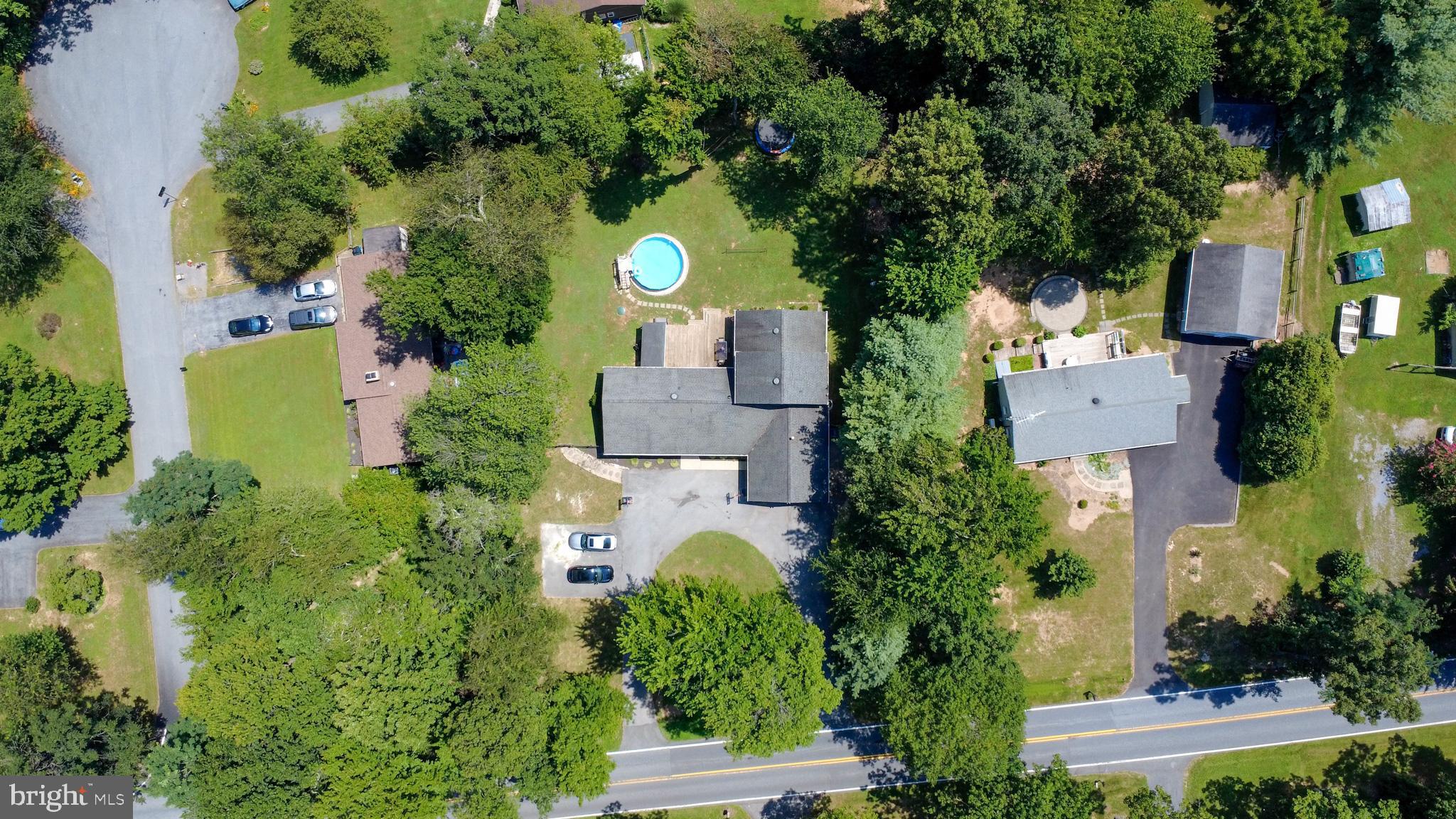 USDA Eligible – No HOA – Over 2,600 Sq Ft on 0.56 Acres with Ample Parking & Outdoor Living!
Welcome to 4105 Lynn Burke Rd, where charm, functionality, and location come together in this beautifully expanded two-level retreat. Offering over 2,600 square feet, this spacious home has been transformed from a classic rancher into a versatile residence with room for everyone—and then some.
Inside, you'll find 4 generously sized bedrooms, 2.5 updated baths, and an additional 10' x 10' bonus room currently used as a bedroom. The private upper-level suite features soaring cathedral ceilings, a spa-style custom bath, and a massive walk-in closet—perfect as a luxurious primary suite, home office, or guest quarters.
The kitchen is a standout, boasting white cabinetry, a striking custom stone backsplash and feature wall, stained butcher block countertops, and a double sink overlooking the expansive backyard. The great room impresses with vaulted ceilings, a custom wood feature wall with a built-in entertainment center (available), and access to the fenced backyard and deck—ideal for summer entertaining or quiet evenings outdoors.
Situated on a 0.56-acre lot, the property features a large circular driveway with parking for 7–10 vehicles, plus a 2-car carport, offering convenience and flexibility for guests, work vehicles, or multi-family households. The backyard is perfect for outdoor living, complete with a fenced yard, above-ground pool, spacious deck, and full-size shed—ideal for relaxing, entertaining, or enjoying sunny afternoons with family.
Additional highlights include:
Hardwood floors and crown molding throughout
Ample storage in the mudroom, laundry room, attic, and shed
No HOA
USDA financing eligible—buy with little or no money down!
Conveniently located just minutes from Adventure Park USA, Green Meadows Petting Farm, Vintage View Cinemas, and major commuter routes (I-70 & I-270), this home offers the perfect blend of privacy, comfort, and accessibility.
A rare find—this move-in-ready home combines spacious indoor living, versatile outdoor space, and unmatched parking capacity. Come see it today!
SEPTIC APPROVED FOR 4 bedrooms. Well at location