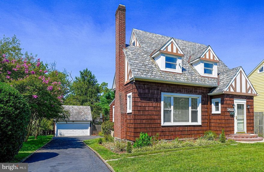 Welcome to this classic Tudor-style home, a perfect blend of charm and contemporary convenience. Nestled in a quiet neighborhood with easy access to 695, the property features a stunning slate roof and cedar shake siding that set a timeless and elegant tone. Inside, you'll find three generously sized bedrooms and two full baths, offering ample space for relaxation and functionality. The upper level is particularly versatile, featuring a kitchenette and the potential to serve as a private in-law suite with its own separate outside entrance, completely separate from the downstairs living area. The heart of the home is the kitchen, complete with radiant heat flooring, granite countertops, stainless steel appliances, and recessed lighting, making it a dream for any home chef. Throughout the living areas and bedrooms, elegant hardwood floors add warmth and continuity to the design. An insulated attic provides additional storage space or the potential for future finished space. A huge unfinished basement includes laundry, an enclosed 1/4 bath, and tons of storage space.  The fenced backyard is ideal for outdoor enjoyment, while the long driveway accommodates several cars, complemented by a two-car detached garage for extra parking and storage.  Don’t miss the opportunity to make this unique property your own!