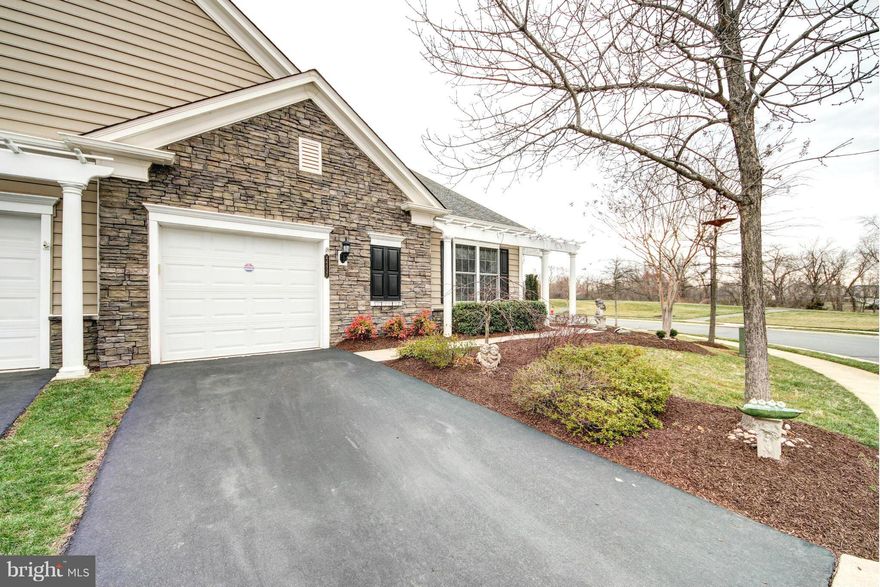 Stunning & unique end unit Villa, Burlington model w/ loft in active adult community of Potomac Green. Upgraded appliances, granite counters, wainscoting & gorgeous details, tray ceiling, bright sun room, spacious Den, heated floors in the 2 main lvl baths,Brazilian Cherry wood floors in this meticulously cared for home. Property faces open space; rare for this model. Plenty of visitor parking!