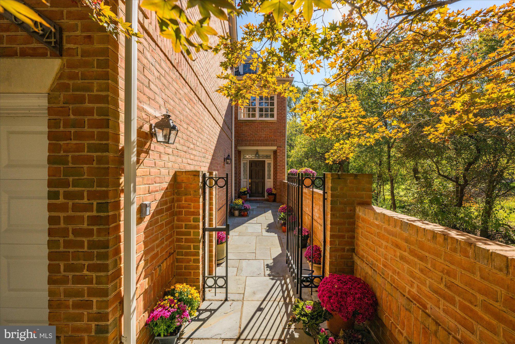 Introducing 9644 Beman Woods Way, an exquisite brick end-unit townhome nestled in the coveted Avenel neighborhood of Potomac, Maryland. This rare and spacious floorplan offers 5,400 square feet across four finished levels, complete with four bedrooms, four full bathrooms and two half bathrooms. With features including a private elevator, a sparkling pool, and an oversized balcony, this residence stands out as a true gem within the Avenel community. As you approach the home, pass through the front gate into a charming courtyard wrapped in slate. This secluded space offers a welcoming seating area and two entry points into the home, through the front door and a side entrance. Step inside the main foyer, where you will be greeted by impressive ceiling heights and an abundance of natural light from oversized windows, a theme that carries gracefully throughout the home. Continuing through the foyer, descend into the great room, a true centerpiece of the home. This inviting space features a gas fireplace, custom built-in cabinetry, and expansive windows that bathe the room in natural light while offering scenic views of the backyard and swimming pool. With ceilings soaring over sixteen feet, this room creates an open, airy atmosphere perfect for gathering and relaxation. Step down to the wet bar, complete with an ice maker, creating the perfect setup for entertaining. Beyond the bar, a versatile bonus room with a walk-in cedar closet easily doubles as an exercise room. This level also includes a convenient bathroom, a relaxing sauna, and an oversized storage room for added functionality. The well-appointed kitchen hosts a central island with bar seating that invites casual dining. Surrounding cabinetry offers generous storage for all your cooking essentials, and the Thermador cooktop and dual ovens elevate your culinary experience. A walk-in pantry provides easy organization, while the butler’s pantry leads effortlessly into the dining room, creating a seamless flow for gatherings and an open, welcoming ambiance. A two-car garage located just off the kitchen ensures effortless access, making grocery trips and unloading a seamless experience. Ascend to the second level, where the distinguished primary suite offers a private oasis. This suite showcases a gas fireplace, custom cabinetry, two spacious walk-in closets, an elegant bathroom, and offers peaceful views of the backyard with double door access to Juliet balconies. Opposite the hall, an oversized second bedroom boasts an en-suite bathroom and is complemented by an adjacent powder room. The third level is not to be missed, featuring two additional bedrooms, a full bathroom, a well-equipped laundry room, and access to a sizable deck. The hall bathroom includes skylights that bring in abundant natural light, while the laundry room, with built-in cabinetry and shelving, ensures optimal organization. A private pool is a remarkably unique feature for a townhome in Avenel. This innovative pool, approximately six feet deep, features a BaduJet system for powerful swim-current capabilities, offering the ultimate experience in both relaxation and resistance training. Elegantly surrounded by a slate patio, this picturesque backyard includes a charming corner pond and custom landscaping, creating an idyllic retreat. Avenel is a distinguished community, offering a host of amenities, including a pool, tennis and pickleball courts, a park, and manicured walking paths. Perfectly situated on Beman Woods Way, in the heart of Avenel, this home features a rarely available floorplan and carries the legacy of having been home to the renowned Bill Anders, astronaut of Apollo 8, and photographer best known for the iconic ‘Earthrise’ photograph. This is a rare opportunity to own a residence in this desirable community—one that will not remain on the market for long. Do not miss the chance to call 9644 Beman Woods Way your home.