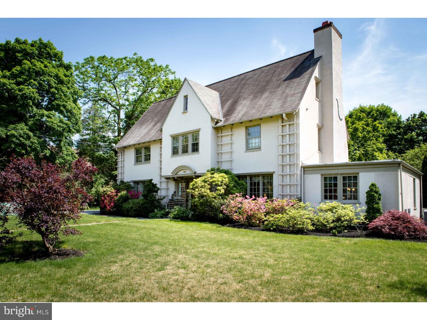 A home this special is not often available: its exceptional street presence and impressive property will draw you in. An elegant foyer with vestibule features original arched french doors. Admire the extensive architectural details, millwork and grand staircase with hand-carved banister; unparalleled craftsmanship appears throughout. Gaze through large windows to a south-facing solarium with wood-burning fireplace and brick patio with stone accent walls. Beautiful original hardwood floors continue through most of the home. The living room features magnificent quarter-sawn millwork, a lovely fireplace with Fuego insert and salvaged bricks from the former middle school, arched doorways and a sunny alcove. A private den with charming brick floors is bursting with light. Entertain in the formal dining room with convenient butler's pantry adjoining; this space provides easy access outside to the drive. The cheerful eat-in kitchen boasts abundant cherry cabinets, counter space, gas cooking, pantry, access to side mudroom and expansive views of the deep and private backyard. The adjacent family room is spacious and can be transformed to meet your needs. Upstairs, take a moment in the delightful window seat. Two master suite options! One bedroom is graced with a wood-burning fireplace, full bath and sitting room. Or create a private entrance to another suite tucked at the back, also with full bath and original built-in closets. The 3rd bedroom on this level offers several windows and connected full bath with original clawfoot tub. The rooflines on the 3rd level create appealing spaces, from the roomy suite with full bath and cedar-lined storage to a 5th bedroom and hall bath with original clawfoot tub. A cozy alcove and two additional rooms offer flexibility. The unfinished basement, separate storage rooms on the main level and plentiful closets provide fantastic storage space. The sellers have loved the character and grace of this home during their long stewardship and have meticulously cared-for and upgraded with today's wishlist in mind, including adding central air, updating systems, adding a generator and moving the laundry to the 2nd floor. Perfectly located in sought-after South Wayne with an easy stroll along tree-lined sidewalks to the St. Davids or Wayne train stations and all that Wayne has to offer. Visit today to discover, be enchanted and make this extraordinary home yours. 2nd parcel included: 244 Pembroke, taxes $1,288 add'l, assessment $40,700.