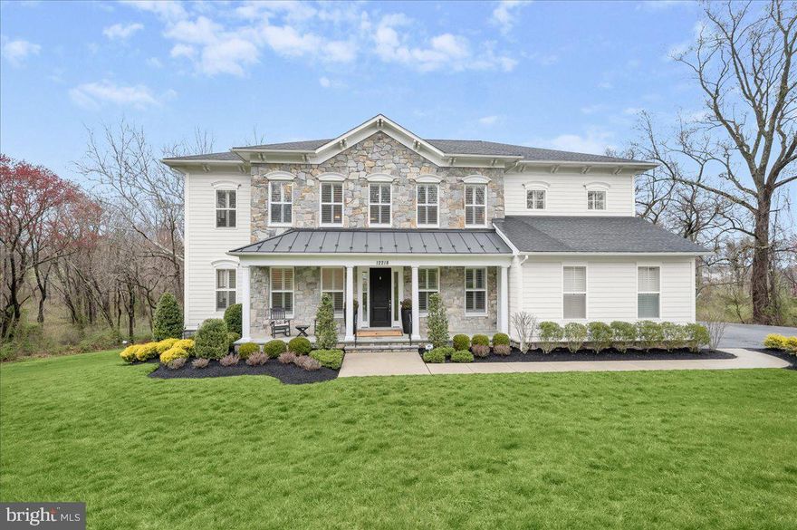 Welcome to one of the finest luxury homes to hit the market in Howard County in quite some time. Located in the exclusive enclave of Highland Reserve, no expense has been spared on this Mitchell & Best masterpiece built in 2018. Boasting 5 bedrooms, 4.5 bathrooms and 6,971 total square feet, this Berkley Floorplan is sited on nearly an acre of land completely surrounded by breathtaking conservation area making the grounds feel expansive and manor-like. This estate features thoughtfully crafted, beautiful outdoor spaces on every level and is zoned for top-tier Howard County schools.

The highlights of the stunning open-concept main level include a double-sided fireplace shared by the screened-in patio, wide-plank hand-scraped hardwood flooring, plantation shutters and two sets of staircases. The kitchen is appointed with a Sub-Zero refrigerator, a Wolf 6-burner cooktop, double oven, quartz countertops and designer pendant lighting. The butler pantry contains its own beverage fridge and leads to the dining room complete with designer chandelier, wallpaper and custom trim work.

A large landing area and loft await at the top of the main staircase on the upper level. The primary bedroom features its own sitting area, covered balcony, and two expansive walk-in closets with custom organizers, one with a jewelry desk and dressing island. The primary bathroom is a spa-like retreat containing a dual shower head frameless shower, two large vanities and a free-standing tub. The secondary bedrooms share a buddy bath, while the guest bathroom features its own en suite bathroom, also with a frameless shower.

You’ll find another bedroom with a large walk-in closet and full bathroom featuring even more designer finishes on the lower level. The large recreation room boasts a media area with built-in surround sound speakers, a large wet bar with beverage fridge and dishwasher, and a gym with rubberized flooring all leading to the impressive patio spaces outdoors. The gorgeous stone paver patio with built-in fire pit provides the perfect backdrop for entertaining. There’s a summer kitchen with granite countertops, custom lighting and a pergola. And the Trex deck features a lighted curved staircase and railings. 12218 Pleasant Springs Court is elegance…defined.