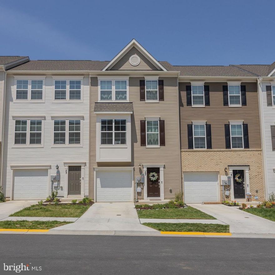 Welcome to this beautifully maintained, nearly new 3-bedroom, 2 full bath, 2 half bath townhome offering 1,922 sq ft of modern living space across three thoughtfully designed levels.  Step into the lower level featuring a welcoming foyer with luxury vinyl plank flooring and a spacious rec room with plush carpet—perfect for a home office, playroom, or second living area.  Access the fully fenced backyard from the rec room.  The second level serves as the main living area, featuring an open floor plan enhanced by luxury vinyl plank flooring throughout.  Enjoy an oversized family room that flows seamlessly into the expansive kitchen, complete with a large island, granite countertops, stainless steel appliances, and a designated dining area. Step out onto the composite deck with vinyl railing—ideal for outdoor dining or relaxing.  Upstairs, the primary suite features a walk-in closet and a spa-inspired ensuite bath with dual sink vanity and a tiled shower with built-in seat. Two generously sized secondary bedrooms share a full bathroom. Convenient laundry room located on the upper level. This townhome blends comfort, style, and functionality—don’t miss your opportunity to call it home!