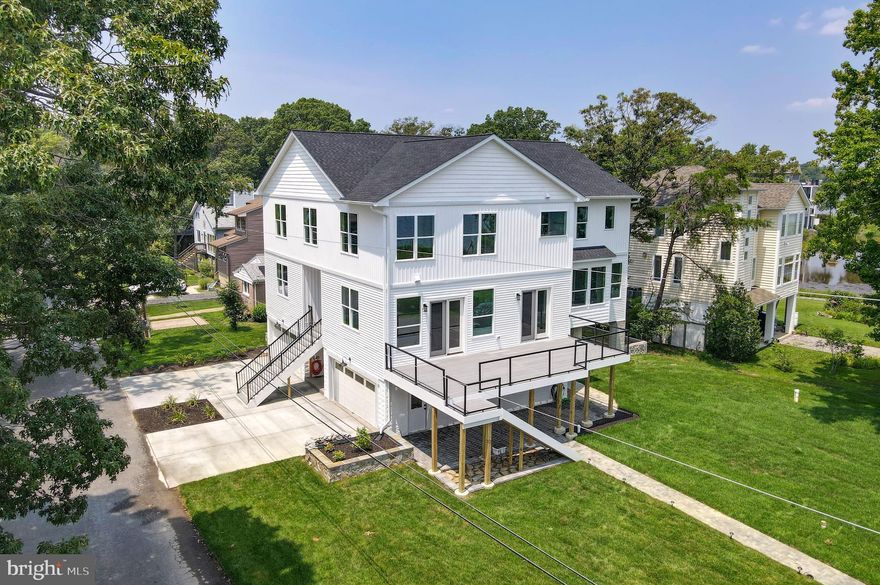 This stunning new 4700 square foot home is the epitome of luxury living with its spacious 6 bedrooms, 5 1/2 baths, and 4 car garage. Situated on the shores of the beautiful Chesapeake Bay, the gorgeous views from almost every window will take your breath away. 

The main level of this home is designed for stylish comfort and convenience and includes a large bedroom complete with a ensuite bath and deck facing the bay, perfect for guests or multi-generational living. The open concept floor plan boasts a large eat-in kitchen with quartz countertops, large island,  stainless steel appliances and 7ft windows overlooking the bay.  The spacious living room  and dining room area offer access to a large deck, perfect for enjoying the stunning sunsets over the Bay. An office and family room with gas fireplace on the main level provide ample space for work and play. The 10 ft ceilings and wide plank hardwood floors add to the airy, spacious feel of this lovely home.

The second level of the home features a stunning primary suite with a beautiful en suite bath and his and hers closets, all overlooking the Bay. Two additional bedrooms, each with en suite baths, provide plenty of space for family and guests. The remaining two bedrooms share a jack and jill bathroom, making it perfect for kids or additional guests. The laundry room on the second floor adds to the convenience of this spectacular home. The 9 ft ceilings on this level and craftsman doors add to the grandeur of this beautiful space.

The 4 car garage provides ample space for vehicles and storage, while dual zone heating and air conditioning and a 22,000kw whole house generator keep your house comfortable even in the event of a power outage.  The home's location in Columbia Beach offers access to community amenities such as tennis and basketball courts, a boat ramp, and two fishing piers.  

There is a gate code for access to community. Please call or text.