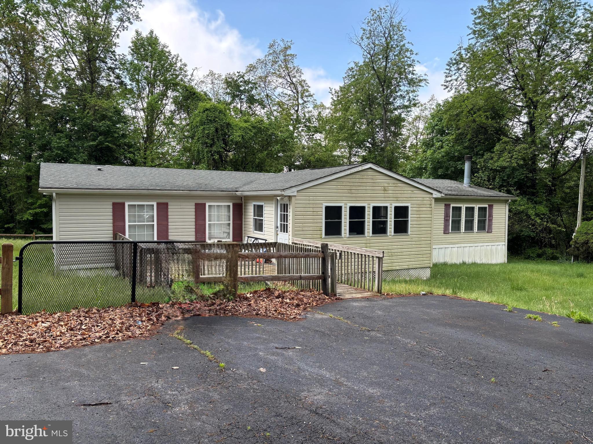 THIS HOME MUST BE MOVED FROM THE PROPERTY AT BUYER'S EXPENSE. PRACTICALLY 100% WHEELCHAIR ACCESSIBLE. Entire home is wheelchair modified and two (2) of the full baths are walk in tubs. Several other items in the house are also modified. Enter home from front deck into three season Sunroom with laminated flooring. Entering home from Sunroom living room with motion censored ceiling light. Main bedroom has walk in closet and a second closet, with an attached main bathroom with french doors, with walk in tub, skylight, hand railings, double sinks and shower stall. Two additional bedrooms with a second full bath with a second walk in tub and skylight. Continuing from the living room to the right is a full size dining room with ceiling fan. Large kitchen with double sink, island with an open floor plan into the family room....which has a stone electric fireplace with fan, surrounded by built in cabinets and shelves. The laundry room, half bath, and mud room are located adjacent to the kitchen with a back door in the mud room leading outside.