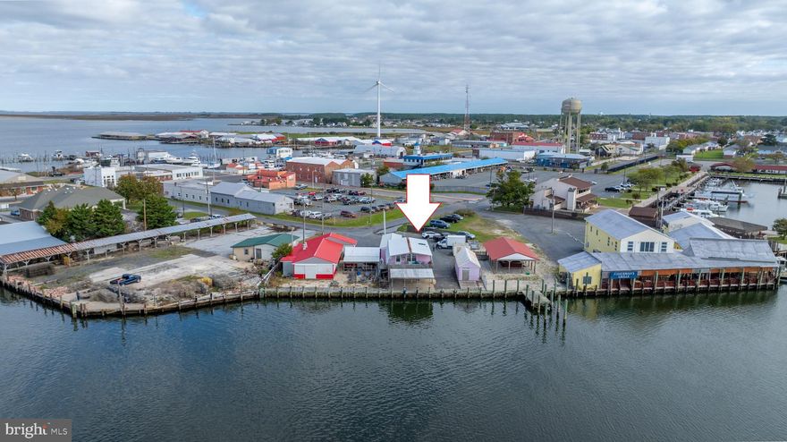 Wow! What a amazing location at the entrance to Somers Cove Marina in Crisfield Maryland. Waterfront investment opportunity offers many potential income streams. Stand alone freezer building with dockside ramp access, stand alone storage building with 8ft drive in door. Main building features 2nd floor 2 bedroom apartment (with stunning views and currently leased), first floor office with additional walk in freezer. Dock access directly in front. See Video!