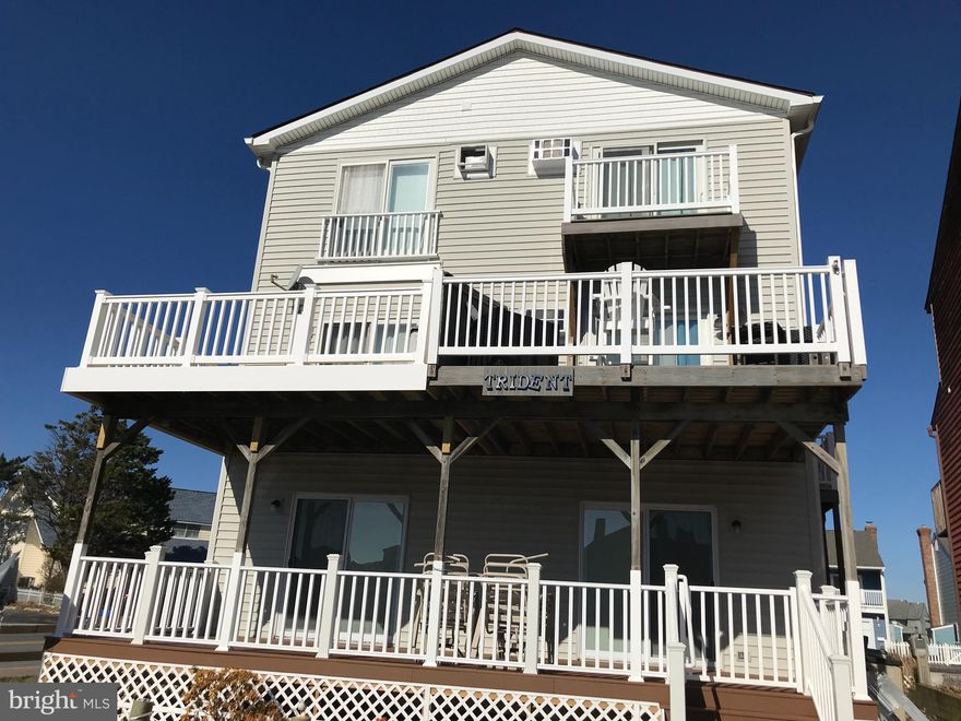 Beautiful & furnished this  2 bedroom 2 bath canal front unit  has a slip and Bayviews from the second floor balcony.  The 2 large bedrooms  are separated from the Living & kitchen area for extra  privacy and extra  guests. A full bath on the first floor makes this space even more desirable.  There are  Luxury vinyl floors throughout the  living area & kitchen and both bedrooms feature new carpeting as of 2021.   All new AC units and ceiling fans, as well a  new electrical panel, kitchen sink/faucet,  dishwasher,& disposal . The spacious  kitchen boosts  granite countertops and updated appliances. There are 2 large decks, one off the master & the other off the living area allowing for outdoor entertainment on the beautiful furniture that conveys with the unit.  There is a green space right outside the dock for outside enjoyment. and the  owners have already paid for a double jet ski lift.  This is a small complex with only 3 units total making it easy to work with the owners.  Come visit today as this unit won't last long.