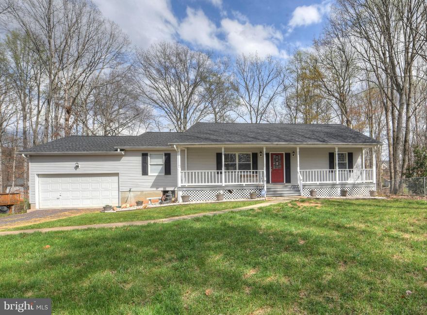 Click the virtual tours link to view video. Spacious rooms w/ unique split floorplan & 4 full baths! Updated kitchen w/ SS appliances, granite countertops, custom cabinets, & hardwood floors. Fully finished basement w/ attached in-law suite, wet bar & rec room. Entertain on Large deck or patio! French doors & sliders for views throughout the house.