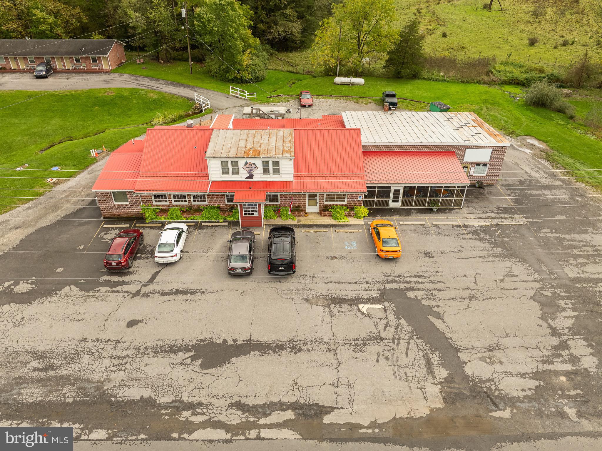 We are excited to present the Lost River Grill and Motel and Lost River Bed and Breakfast as a turn-key business in the heart of Lost River Valley. Operating for over 25 years, locals and tourists alike appreciate the warm and cozy atmosphere for celebrating milestones or just taking a break from their busy lives. Up to FOUR income streams including restaurant, motel, bed & breakfast, and office rental gives a motivated buyer the opportunity of a lifetime. Restaurant with rustic décor has four (4) main dining areas seating approximately 80 customers at a time. The favorite area for many is the charming bar area accentuated with stone flooring and a warm fireplace. Lost River Bed and Breakfast. The 5 Bed/5.5 Bath home can be used as owners’ residence or a private Bed and Breakfast for travelers looking for luxury accommodations. The ten (10) room motel has been preserved to bring back simpler times of travelers exploring the area. Mountain views for your guests from every doorstep of the various businesses. The Lost River Valley is only 2 hours from DC Metro Area and has so much to offer such as trail hiking, trail biking, horseback riding at Lost River State Park and swimming at Trout Pond National Recreation Area. We can’t just tell you how special the area is, you will just have to come see it to understand. Make an appointment today!