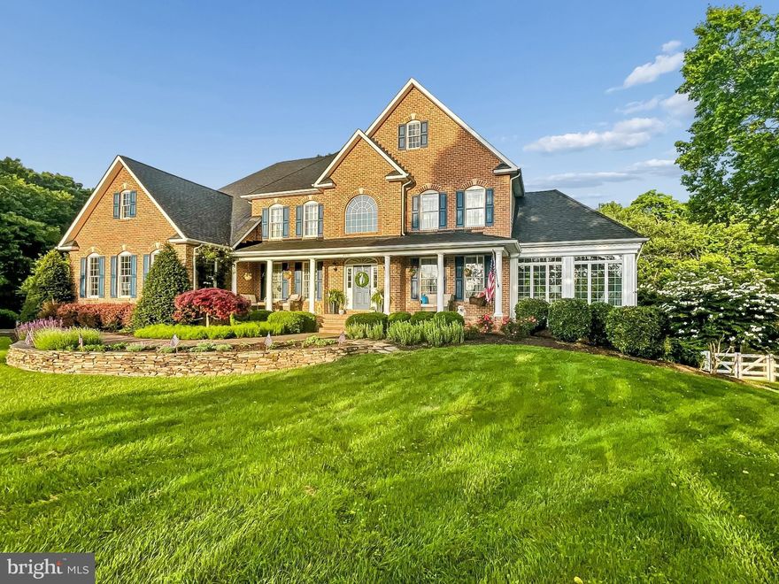 Nestled within the prestigious enclave of Little Caledonia, this exquisite Wilson Home built residence embodies the pinnacle of luxury living. Spanning nearly four acres, this traditional Colonial masterpiece is a harmonious blend of elegance and comfort, offering a resort-like lifestyle, fit for a homeowner's dream. As you approach the property, the stately brick façade exudes timeless charm, complemented by cherry blossomed tree lined drive & professional meticulously landscaped grounds that create a serene atmosphere. Step inside to discover an interior that radiates sophistication, luxury, & warmth. The 18-foot high grand foyer welcomes you home with rich hardwood flooring, accentuated by crown moldings and a stunning open chandelier . The open floor plan seamlessly connects the formal dining room and living areas, perfect for entertaining or intimate gatherings. A cozy wood-burning fireplace, framed by elegant mantels, serves as a focal point in the living space, inviting warmth and comfort. The family room additionally offers a custom built-in perfect for entertainment equipment, private storage & special decor items for display. The gourmet kitchen is a culinary enthusiast's dream, featuring stainless steel appliances, a spacious island, granite countertops and an abundance of cabinetry, including a pantry for all your storage needs.  The adjoining breakfast area offers picturesque views of the lush rear yard, while the family room off the kitchen ensures that everyone can gather in style. The conservatory room adds an exceptional addition to the home, boasting captivating views of the outdoors ensuring this room is a delight to relax in during all 4 seasons of the year. 
Retreat to the second level to the luxurious primary suite, where tranquility reigns. This sanctuary boasts vaulted ceilings, a walk-in closet, and a private sitting area. Attached to the suite is a completely renovated spa-like bathroom complete with a soaking tub, a walk-in shower with sitting area, and heated marble floors providing a perfect escape after a long day. The additional 3 bedrooms on this level include spacious layouts, bathroom access & generous closet space, making any of these rooms a delight to live in.

The outdoor oasis is equally impressive, enhancing the resort living style of the home. Featuring a fully updated personal in-ground, gunite pool that is self-cleaning & heated, allowing you to fully enjoy without the hassle of daily maintenance & concerns of cool temperatures. The pool is accompanied by a spacious deck (built 2024), New poolside patio & walkways composed of flagstone & local natural stone, ideal for sun-soaked afternoons and evening gatherings. The property backs to trees, offering a sense of privacy and a scenic vista that enhances the natural beauty of the surroundings. Additional highlights include 3 car garage, private bonus room, back staircase for convenient kitchen access, a basement with a walkout level, providing endless possibilities for customization, and a spacious main-floor laundry for convenience.   
With its stunning views of the creek, breathtaking landscape and lush greenery, this residence is not just a home; it's a lifestyle. Experience the perfect blend of luxury, comfort, and nature in this exceptional property, where every detail has been thoughtfully curated for the ultimate living experience.