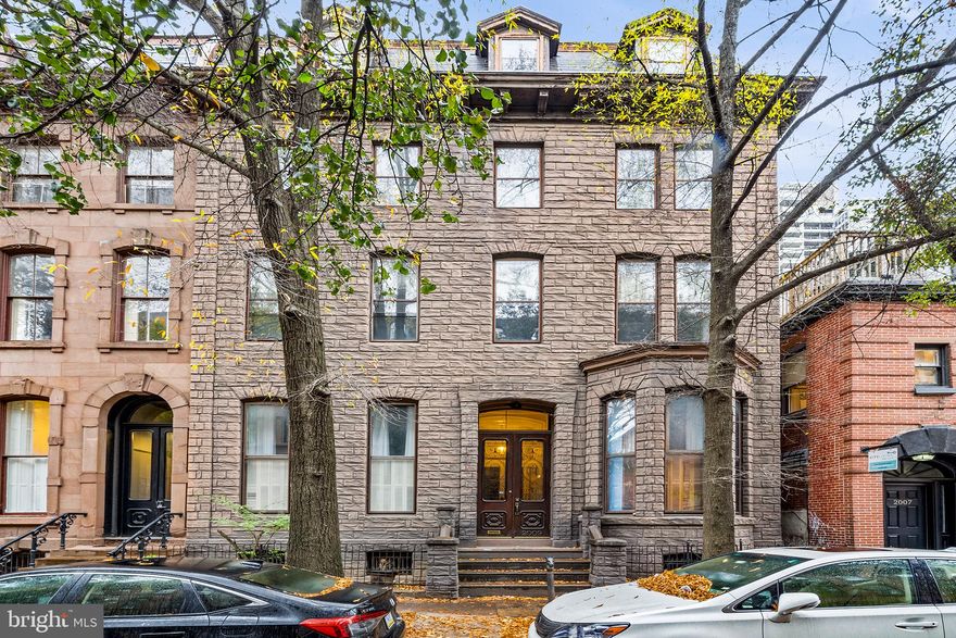 Dreaming of renting a striking space in a historic building off Rittenhouse Square? This pet-friendly home is perfect; both as a large and comfortable living space, and as an inspiring work or studio space. Colorful design and art, original details and maximal space - it provides over 2,100 sqft above ground and an additional 1,700 sqft of space in the finished basement. You'll immediately notice the soaring 13-foot ceilings, fluted columns, and incredible historical details - with luxurious design including custom window treatments, built-ins by Philadelphia Wood Co, and Tom Dixon lighting. Get inspired in the grand living room with inlay flooring and plaster details. The breakfast nook or entry area includes built-in storage in periwinkle millwork. Follow the brass railings up into the dining room! A large, mirrored space, perfect for hosting and with direct kitchen access. The kitchen has tons of cabinetry, new appliances and countertops. Completing this wing of the first floor is a guest room or office, with an en-suite bathroom and closet/dressing area. Down a meandering hallway you'll find a second, more private wing. This primary suite is easy to close off from the main living space. The bedroom is magical and cozy with a king bed - custom drapes hanging happily from a large bay window. The full bathroom is adorned in cut marble and has a shower/tub combo. From the primary suite hallway is a staircase to the lower level and bonus space(s). It offers additional living space, with its own living room (or home gym, playroom, etc.), a full bathroom, and another bedroom/yoga room/studio. There is a very large storage closet, wine cellar, and laundry room. With the possibilities to be rented furnished or unfurnished, it's truly a rental filled with opportunities!  2009 Spruce St Unit C offers convenient first-floor living, with all the security of a condo.  It's tough to find such luxury in this dreamy of a location - steps from the best in Rittenhouse Square, blocks from Schuylkill River Trail and Dog Park, and close to delightful coffee shops, boutiques, and restaurants like Parc, Trattoria Carina, Via Locusta, and so much more!