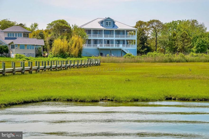 One of a Kind Direct Bayfront Property! This Beautifully furnished 6BR 5BA waterfront home features a large, open living area with a cathedral ceiling, a dual gas fireplace and awesome bay views. Interior features include hardwood flooring, ceramic tile, custom kitchen with corian counters, ceiling fans, crown molding and custom baths. Wraparound decks offer fabulous outside areas to enjoy the panoramic bay views and the Ocean City Skyline! The large 1.98 acre lot extends to the waterfront and the 400ft pier with a boat lift and jet ski lifts! The first level garage contains 4 parking spaces and lots of storage area. This ''Must See Property'' is secluded in West Ocean City and you have no idea how close you are to the beach and restaurants!