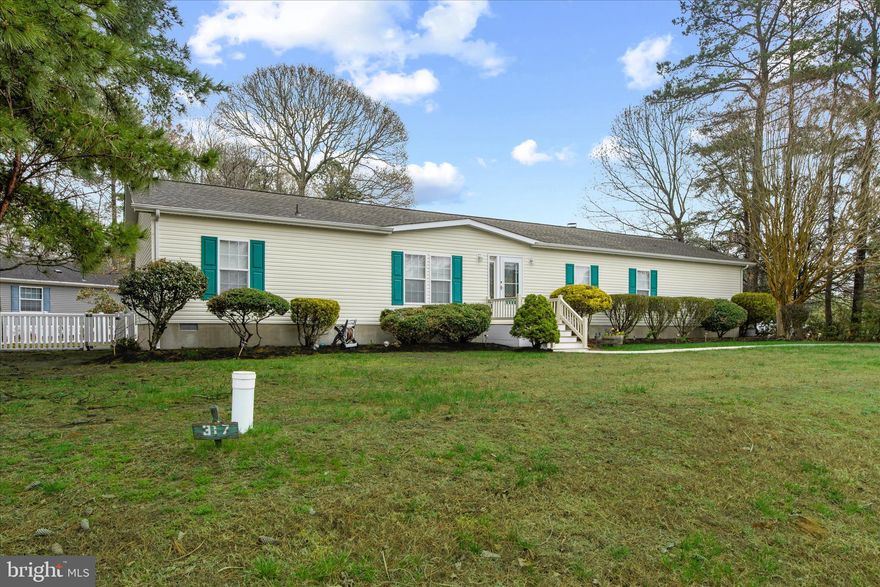 Beautiful ranch-style home on a large, 1/3 acre cul-de-sac lot in Angola Estates. This is single story living at its finest in a desirable waterfront community in Lewes! This home features a formal living room, large dining room, spacious eat-in kitchen with a breakfast bar, comfortable family room with a stone-faced fireplace, gorgeous architectural windows for lots of light, and a large screened porch overlooking the fenced backyard with its attractive landscaping.  Four bedrooms, including a master suite with an ensuite bathroom offering a soaking tub, double sinks and separate shower, and an additional full bathroom are arranged in a split floorplan. The separate laundry room has a convenient side entrance leading to the oversized driveway. Lots of parking for family and friends! This home features real hardwood flooring in the living and dining rooms, and also in the master bedroom! Newer luxury vinyl plank in the family room. The community offers two pools (one just around the corner!), a floating dock marina, fishing and crabbing pier, boat ramp, fenced storage yard for RV's/boats/trailers, community center, 2 playgrounds, basketball and tennis courts, kayak and canoe storage, and plentiful common spaces. Park application required; credit and background checks, verification of income. Land rent includes sewer, trash and recycling.