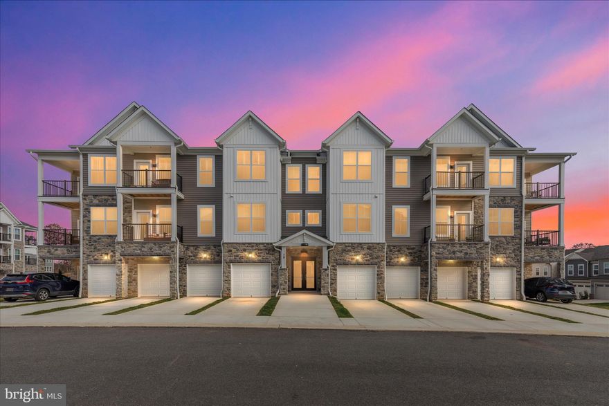 Welcome to this stunning new one-level active adult condo in the premier Cascades at Embrey Mill community  where comfort meets style. Step into a spacious foyer with an elegant tray ceiling and an open floor plan featuring luxury vinyl plank floors and designer finishes. The chef-inspired kitchen impresses with a large island with bar seating, quartz countertops, custom backsplash, stainless steel KitchenAid appliances, modern gray cabinetry with pull-out shelves, and a generous walk-in pantry. The kitchen opens seamlessly to the dining area and bright, inviting living room perfect for entertaining or relaxing. A versatile built-in office with custom cabinetry offers the ideal work-from-home space. The laundry room includes a brand-new washer and dryer for added convenience. Retreat to the luxurious owner’s suite with a spacious walk-in closet and an elegant bath featuring dual quartz vanity, a frameless glass shower, private water closet, and an upgraded tile package. Two additional bedrooms and a full hall bath provide flexible options for guests or hobbies. Enjoy beautiful sunsets and tree views from your private balcony. Additional highlights include custom remote-controlled blinds, a one-car garage, extra storage, and shared elevator access. This home also features smart-home technology including programmable thermostat, keypad entry, CAT6 wiring and energy-efficient construction for modern living. Residents of Cascades enjoy resort-style amenities: clubhouse, pool, fitness & yoga studio, patio with fire pit & grills, pickleball and bocce courts, and more. Do not miss your chance to own this exceptional home - schedule your showing today!