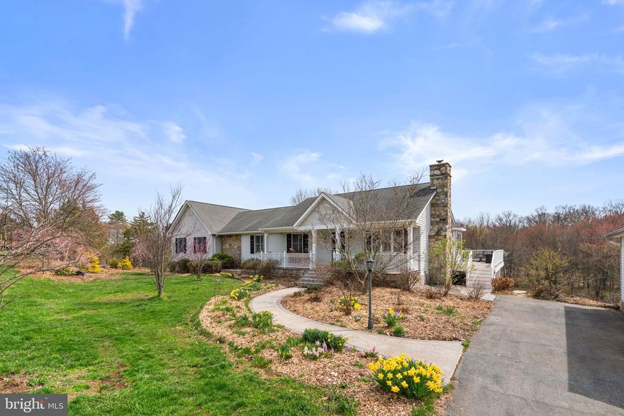 Welcome to a truly one-of-a-kind homestead where lifestyle, sustainability, and natural beauty come together in perfect harmony. Nestled on a picturesque property with a serene stream, this thoughtfully designed residence offers over 4,400+ finished square feet and an extraordinary outdoor experience you simply won’t find elsewhere.

Inside, the home has been freshly painted, features refinished hardwood floors, and a beautiful open kitchen creating a warm, clean, and move-in-ready space. A stunning wood-burning stone fireplace with a mantle serves as a cozy focal point. With 4 bedrooms (including 2 oversized primary suites), 3 full baths, and a fully finished lower level, there is room to live, gather, and grow—whether you're hosting, working from home, or creating a multi-generational living space.

Outdoor living is just as impressive. The expansive deck and screened porch—each approximately two-thirds the width of the home and generously sized—offer incredible spaces to relax or entertain while taking in the peaceful surroundings. Enjoy the soothing sounds of a custom-built waterfall with large stone steps, perfectly positioned between the home and detached garage, creating a tranquil setting that can be heard from both the deck and screened porch. A private patio with direct access from the secondary primary suite provides a quiet retreat, while a convenient covered potting area with water access adds ease and function for gardening enthusiasts—all thoughtfully positioned just steps from the home.

But what truly sets this property apart is what awaits outside…

Step into your own private food forest and garden oasis, carefully cultivated with an incredible variety of fruiting trees, shrubs, and perennial harvests. Enjoy seasonal abundance from:

🍑Peach (white & yellow), Nectarine
🍎 Apple (McIntosh, Fuji, Gala)
🍐 Pear (Bosc & Bartlett)
🍒Cherry (Rainier, Bing, sour & bush varieties)
🍇Grapes (Concord, green & blush table)
🫐Elderberry (Nova & York), Currants (black, red, white)
🌰Hazelnut & Walnut
🍓Raspberry (red, black, yellow) & Blackberry
🍊Persimmon (American & Japanese)
🌿Asparagus (purple & green), multiple Fig varieties

For the culinary enthusiast or homesteader, the property also features a gourmet mushroom growing area near the stream, including multiple varieties of shiitake, oyster, and lion’s mane, along with wine cap mushrooms seeded throughout the garden—producing fresh harvests throughout the year.

Animal lovers will appreciate the impressive Amish-built chicken coop (approx. 8x28) designed to accommodate up to 70 birds, complete with a metal roof and gutter system for water collection, predator-proof enclosed run, multiple access points, attached storage, and an easy-clean design.

Whether you're dreaming of a self-sustaining lifestyle, a hobby farm, or simply a peaceful retreat with unmatched outdoor amenities, this property delivers.

Located in the heart of Carroll County, this home offers the perfect balance of privacy and convenience—just minutes to downtown Westminster with local shops, restaurants, and community events, close to McDaniel College, parks, farms, and scenic countryside, with easy access to Baltimore, Frederick, and southern Pennsylvania.

Enjoy the charm of rural living with everyday essentials just minutes away.

This isn’t just a home—it’s a lifestyle property. From the mature orchard and garden space to the thoughtfully designed outdoor features and beautiful natural setting, every detail has been curated for those who value sustainability, self-sufficiency, and connection to the land.