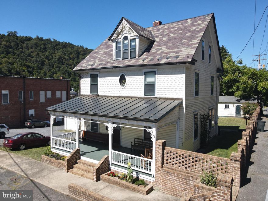 Downtown Berkeley Springs at it's finest.  A nice colonial style home boasts plenty of potential. With 5 Bedrooms, 5 full baths,  a full basement for storage, large fenced rear yard, a garage, covered porches (front and back), and an apartment in attic with a kitchenette  home could be perfect for a number of uses. New HVAC was installed.  Home features a slate roof, bullseye trim, pocket doors, hardwood floors, detailed woodwork on the stairs and banisters, and much more.  A real gem of a home in a great location!