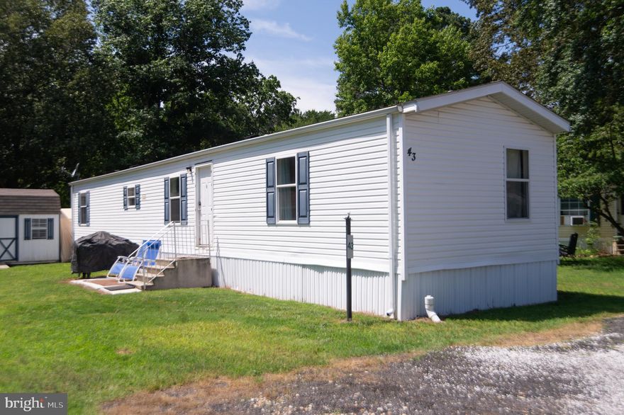 Adorable and move-in ready 3BR/2BA single-wide home located in the quiet community of Prettyman Manor.  A private driveway with parking for three cars sits just steps from the front door of your new home.  Step inside to an inviting open floor plan with a spacious living room featuring a cozy wood-burning stove, and a well-equipped kitchen with plenty of cabinet and counter space, plus a double stainless sink beneath a window.  At the front of the home, you’ll find two comfortable secondary bedrooms and a full hall bath.  Pass the laundry area on the way to the private primary suite, offering a full bath with a walk-in shower.  Outside, enjoy a spacious yard with plenty of green space and room to garden.  This move-in ready home offers affordability and convenience, close to shopping, dining, and major commuter routes.