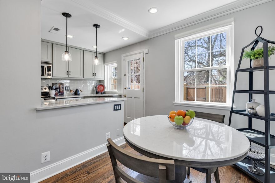 Gorgeous 2-bedroom, 2-bathroom Clarendon II model townhome nestled in Fairlington Villages! This beautifully updated home features refinished & richly stained hardwood floors on the main & upper floors, updated bannisters, spindles, & door hardware throughout. The spacious living room flows into the dining area, which are both accented with crown molding & recessed lighting - creating the perfect space for everyday living or entertaining. The renovated open kitchen showcases updated gray cabinetry, stone countertops, a gray subway tile backsplash, stainless steel appliances including newer dishwasher (2025), a peninsula with pendant lighting, & pantry cabinets for excellent storage. Just off the kitchen, step outside to the private back patio with a newly installed fence (2025) - ideal for relaxing, grilling, or enjoying time outdoors.

Upstairs, the beautifully updated bathroom features tile flooring, a white stone-topped vanity, and a white tiled shower with convenient corner shelving. The spacious primary bedroom is accented with crown molding, contemporary paint, a chandelier, & includes a large walk-in closet with custom built-ins. The second bedroom also offers a closet with built-in organization and plenty of natural light.

The lower level features durable LVP flooring and recessed lighting throughout the large recreation room, along with an under-stair utility/storage area for added convenience. A versatile bonus room with tile flooring, overhead lighting, and a closet provides the perfect space for a home office, guest room, or gym. The lower-level bathroom includes a white vanity, dark tile flooring, and a white tiled corner shower, along with a convenient laundry nook featuring a newer full-sized washer (2024) & dryer and overhead shelving. This home comes with two reserved/unassigned parking spaces. Fairlington Villages residents enjoy six pools, lighted tennis courts, tot lots/playgrounds, walking paths, and MORE! Ideally located near I-395 and the shops & restaurants at The Village at Shirlington, West Alex, Baileys Crossroads, Del Ray, & Old Town.