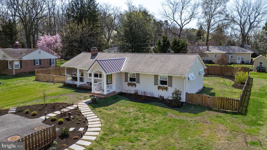 Enjoy easy one-level living in this charming 3-bedroom home located in the highly desirable Oxford Road corridor, offering lovely views of Peachblossom Creek and access to private waterfront lot . Inside, the home features a bright open kitchen with a marble island and huge walk in  pantry. The living room offers a cozy gas  insert fireplace, while the foyer welcomes you with attractive tile flooring. A heated, semi-enclosed porch provides a comfortable space to enjoy the outdoors year-round. The primary suite includes Large walk in closet with built in features.  The  primary bath has  a no-threshold tile shower and custom vanity with double sinks. Additional highlights include a laundry room with washer, dryer, and folding table, a partially floored attic for extra storage, and a new metal roof installed in 2025. Fenced rear yard with shed.  A wonderful opportunity to enjoy relaxed Eastern Shore living in a prime location near the water and close to downtown Easton,shopping, YMCA , bike trails, and parks.