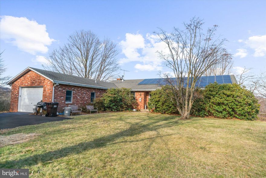 A tree-lined drive leads to breathtaking views  with this three bedroom, 2.5 bath ranch home on more than seven acres of what once was an orchard, fruit trees and native plantings still gracing grounds.  A timeless solid brick ranch home, with living room, family room, two brick fireplaces, and a full basement with a finished area that gives another 1000+ sq ft of living space along with a workshop that provides access to grade.  Enough can not be said about the lot, with panoramic views and what was once a beautiful in-ground pool with spa along with a detached garage and shed for additional storage.  The home and grounds need life breathed back into them, and when they do, this property will be worth as much as the views...