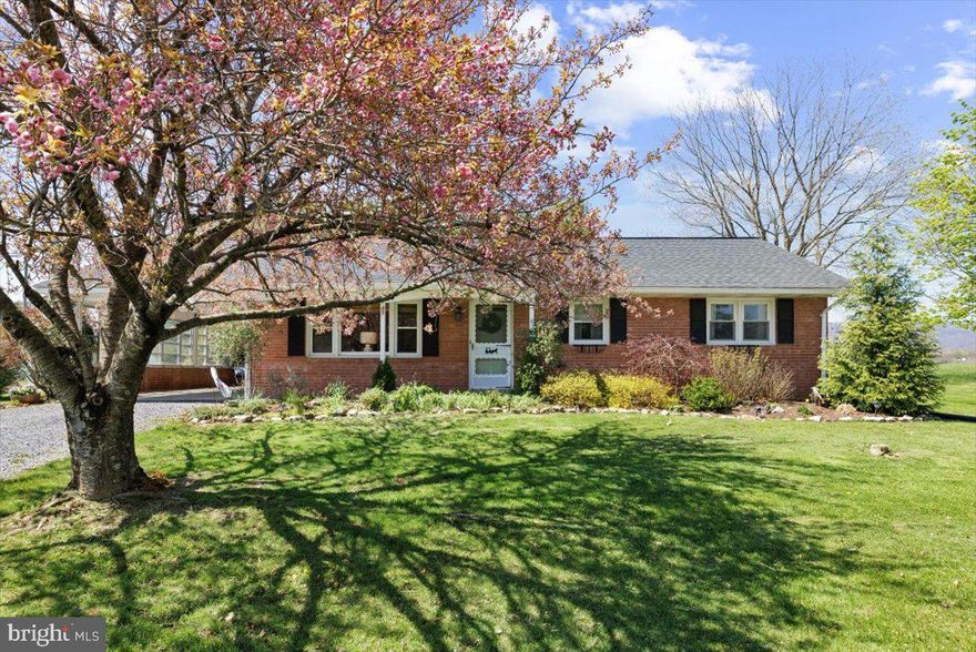 Discover the charm and tranquility of 2447 Rittenour Rd. in Woodstock, VA! Nestled on a beautifully landscaped 0.469-acre lot, this all-brick ranch home offers the perfect combination of timeless design and breathtaking natural surroundings.

A new roof was installed just 3 years ago, ensuring durability and reducing maintenance worries. The home’s sturdy brick exterior and classic design are matched by practical features like an attached carport, ideal for protecting your vehicle from the elements.

Boasting 1,218 sq. ft. of well-planned living space, this home features 3 bedrooms and 1 full bathroom, providing comfortable accommodations for family or guests. The full, unfinished basement presents a blank canvas for customization, whether you envision additional living areas, a home gym, or ample storage space.

Step outside and immerse yourself in the stunning surroundings. The landscaped yard is not only a gardener’s delight but also a perfect spot to relax and take in the panoramic mountain views. An outbuilding with electricity offers endless possibilities, from a workshop to extra storage for tools and equipment.

Located in a quiet, scenic area, the property is serviced by town water and trash utilities, providing the conveniences of modern living without sacrificing the peaceful charm of rural life.
Whether you’re a first-time homebuyer, a downsizer, or someone looking for an investment property, 2447 Rittenour Rd. has it all. Don’t miss the opportunity to make this delightful home your own—schedule your showing today!