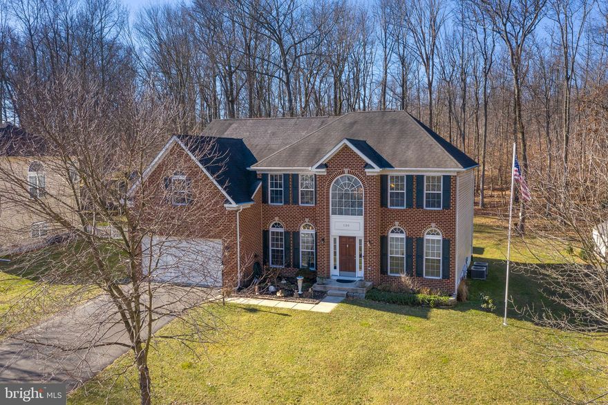 Gorgeous brick front colonial with over 5000 square feet of living space.  Two Story foyer welcomes you in to this beautiful home. First floor features wood floors through out your formal living room, formal dining room, and family room that opens to your expansive kitchen with a sun room.  The family room features a gas stone fireplace surrounded by floor to ceiling windows. Follow your imperial (dual) staircase upstairs to an extraordinary primary bedroom with tray ceiling, 2 walk in closets, and a grand primary bathroom.  Three other bedrooms complete the upstairs. One of the bedrooms include an en-suite bath while the other two bedrooms are adjoined by their own bathroom.  Continue on to the basement that is freshly painted and has all new carpet. Possibilities galore in the wide open space with a full bathroom and an area you could turn in to a 5th bedroom or an in home theater. Enjoy the upcoming spring and summer nights on your large trex deck .  Your .79 acres backs to woods and is wooded on one side giving you seclusion.  An additional driveway great for parking RV's, boats, or extra cars! House is plumbed for a central vacuum and is wired for a generator.