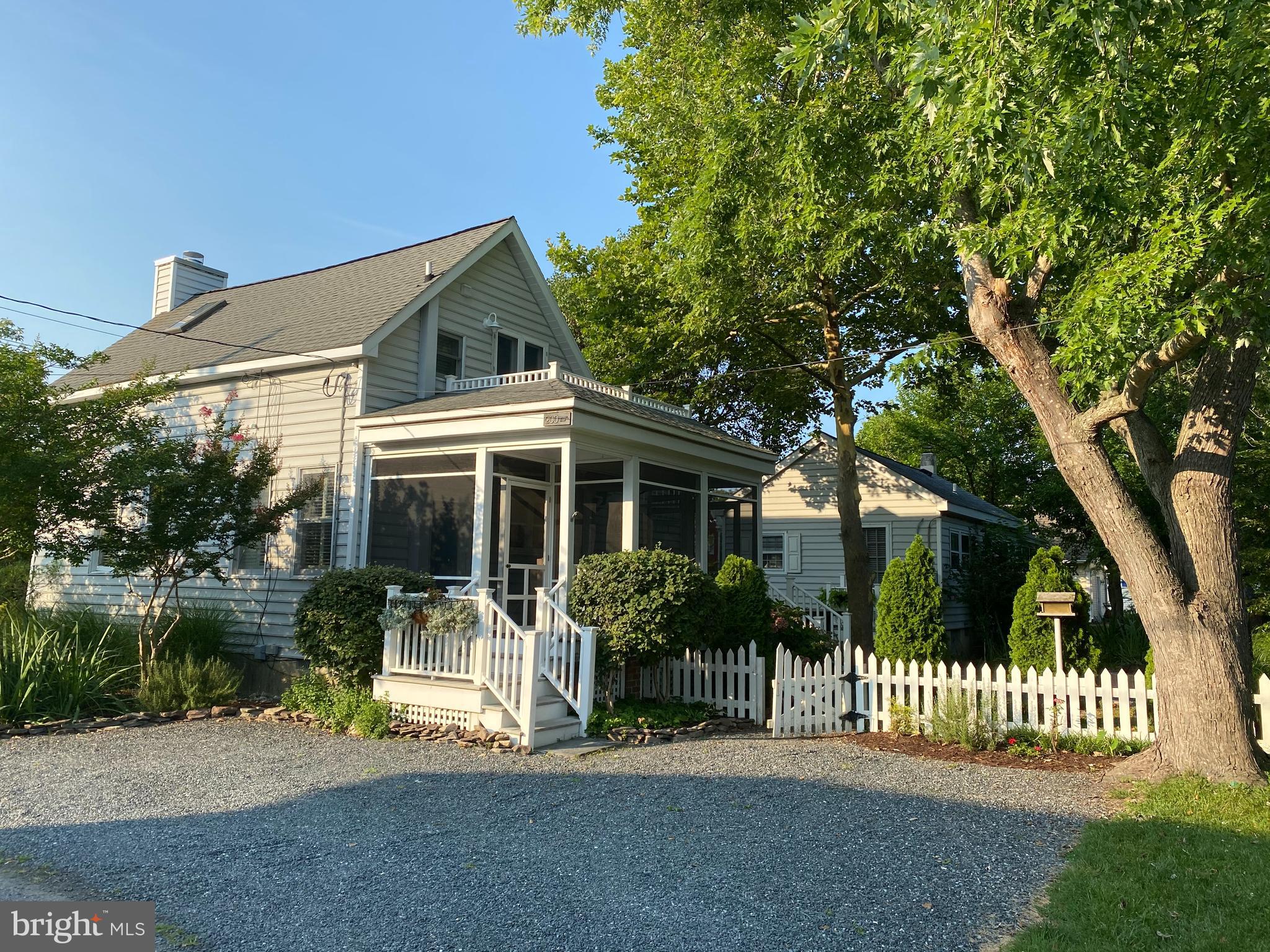 HUGE PRICE REDUCTION!!! Enjoy "the land of pleasant living" at this unique property in Oxford, one of the Eastern Shore's most sought after towns. Very special property centrally located in heart of the Historic Distract. Boat dockage, beach, waterfront park, museum, market and ice cream parlor all close by.
two community tennis courts, restaurants and local theatre. Excellent walking and bicycling.. Gorgeous lush landscaping with minimal upkeep! The property has two high-quality houses (both easily rentable, and licensed for same) that satisfy contemporary requirements for comfortable living.. Community Center, bank, post office, museum, and food/wine market all close by. Both houses were totally remodeled in 2003/2004, including new high foundation and encapsulated/ sealed crawl spaces. The main house has a first story bedroom with tiled bath, plus a large second story bedroom and bath. The dining area is off the modern kitchen, and the living room (with gas fireplace) is open to the dining area. The screened porch and raised deck provide additional living and dining areas. Downstairs flooring appears to be antique chestnut, while upstairs is antique yellow pine. The second house is one story and features Living Room (16 x 8); Kitchen (9 x 8); Dining Area (8 x 6); Bedroom 10 x 10; tiled bath with stack washer/dryer; screened porch (18 x 9); pine floors, electric heat and central air conditioning, ceiling fan and vaulted ceiling. Each house has off-street parking for two cars. July 2021 property inspection report can be made available to buyer. HVAC is via Mitsubishi "Mr. Slim" through-the-wall split system heat pump in the big house, and regular heat pump in the little house. Electric baseboard back-up heat in the big house. High speed WI-FI internet for both houses is from Breezeline. Electric is Delmarva Power. The furnishings are available for purchase.