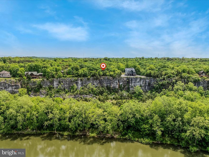 Discover this extraordinary 7.98-acre lot, perfectly positioned high above the Potomac River with sweeping views  including  the C&O Canal Towpath. Located in a neighborhood filled with custom homes, this property offers a unique chance to create your dream residence in a serene and picturesque setting.

The lot is fully equipped with essential improvements, including a well, septic system, electricity, and a private driveway. With these conveniences in place, you can focus on designing a home that perfectly suits your lifestyle and preferences.

Enjoy exclusive community river access, offering endless opportunities for outdoor recreation along the Potomac River including fishing and kayaking.  Despite its peaceful ambiance, this sought-after location provides easy access to major commuter routes such as I-81 and 15 minutes from the MARC train, ensuring a perfect balance between privacy and connectivity.

Don’t miss this incredible opportunity to build your custom dream home in a neighborhood renowned for its beautiful residences!
