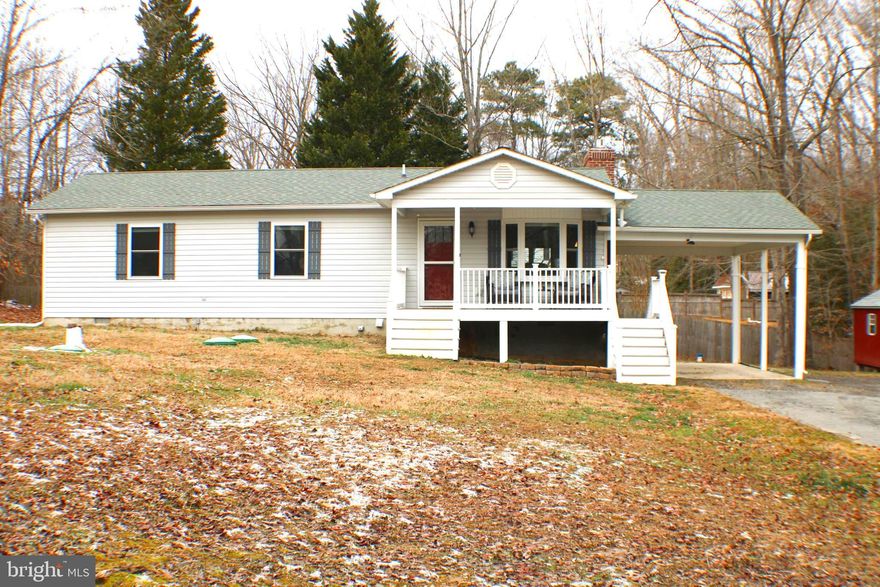 Welcome to 43066 Joy Ln, in Hollywood, Maryland. Not only does this 3-bed, 2-bath home have a prime location and a great lot, it boasts the perfect open concept kitchen-living-dining room in a home this size. As you enter the home you’ll find yourself in the living room which features a large bay window overlooking the charming front porch, made of composite decking. The living room is open to the stunning and inviting kitchen, where you’ll find yourself drawn to the island. The kitchen has stainless steel appliances, black granite, recessed lighting and upgraded cabinets with gorgeous detailing including crown molding. The eat-in-kitchen also features a fireplace with a gas insert and white washed brick. Just off the kitchen through the sliding glass door with built-in blinds is the large concrete back deck, perfect for entertaining. At the end of the hallway is the primary bedroom with an attached bathroom. The home as 2 more bedrooms and a second bathroom with a tub-shower combo and an attached linen closet with plenty of storage. Across from the bathroom is the laundry room with additional space for more storage as well. Below the back deck is a large storage area with electricity, there is also an additional storage shed on the property. The attached carport features an additional set of stairs leading to the front porch. There is a large driveway with plenty of parking. The outside of this home received lots of upgrades that are all less than 5 years old, including new siding, a new roof, a new porch, and a carport.
