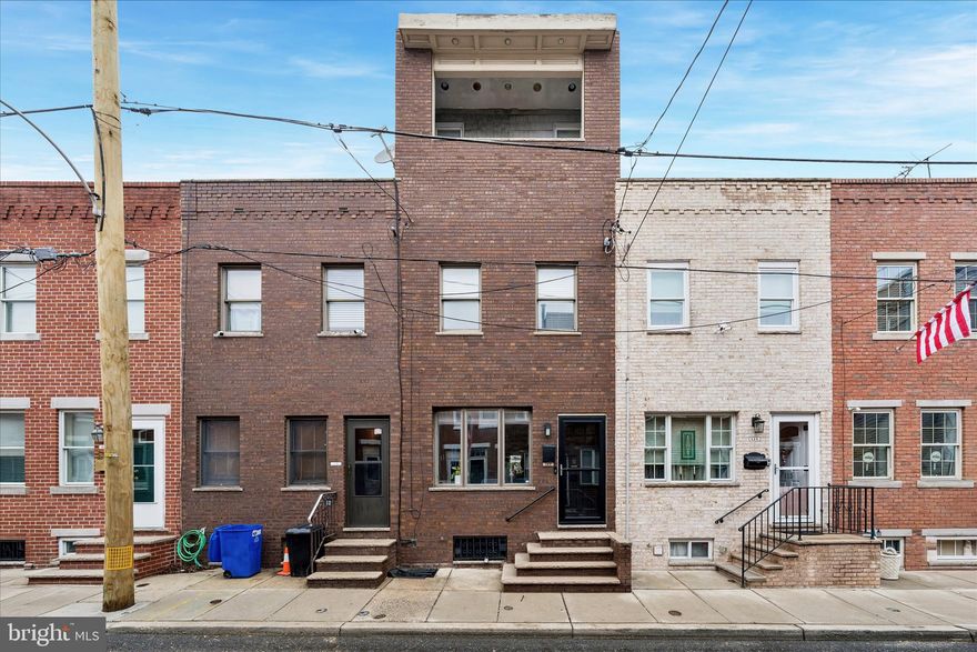 Welcome to 117 Hoffman St — a charming South Philadelphia rowhome nestled in the highly desirable Pennsport section of Philadelphia.
Step inside to an inviting open-concept main level featuring warm hardwood floors, high ceilings, and abundant natural light. The spacious living and dining areas flow seamlessly into an updated kitchen complete with sleek cabinetry, stainless steel appliances, ample counter space, and a stylish backsplash — ideal for both everyday living and entertaining.
The second floor offers two generously sized bedrooms with ample closet space and a well-appointed full bathroom. The entire third floor is dedicated to a private primary suite, complete with your own balcony,  creating a true retreat with separation from the rest of the home — perfect for relaxing at the end of the day. The unfinished lower level provides bonus space ideal for a home office, gym, or simply extra storage space!