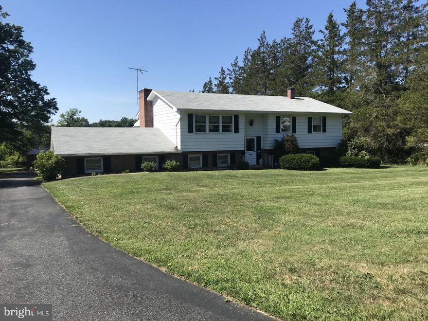 This immaculate,  4 bed, 1 1/2 bath split foyer is  located in a  countryside setting on just under 1 acre.  As you approach the front of the property, you'll notice  a level, nicely landscaped front yard.  Driving to your secure 2 car garage around the back of the home you will see a large level backyard and a shed. The home features a large lower level family room that boasts  a huge brick hearth wood burning fireplace. Nicely finished double french doors gives one a walkout to the 25X10 brick paver patio. As a bonus, there is a fourth bedroom with half bath just off of the family room. From here you enter a 24X15 utility room that features a workbench, brand new sump pump, H/W heater installed 2018, well holding  tank installed 2018 and a furnace upgraded in 2018 plus lots of storage. Heading up to the main level, there is a living room/dining room combination that offers lots of open space with a double french door walkout to a covered 11X10 elevated covered deck. The kitchen features all of the appliances you'll need. The master and 2 bedrooms are just down the hall with a full bath to share. Lots of natural light throughout this gem.. Kingsville at it's finest!