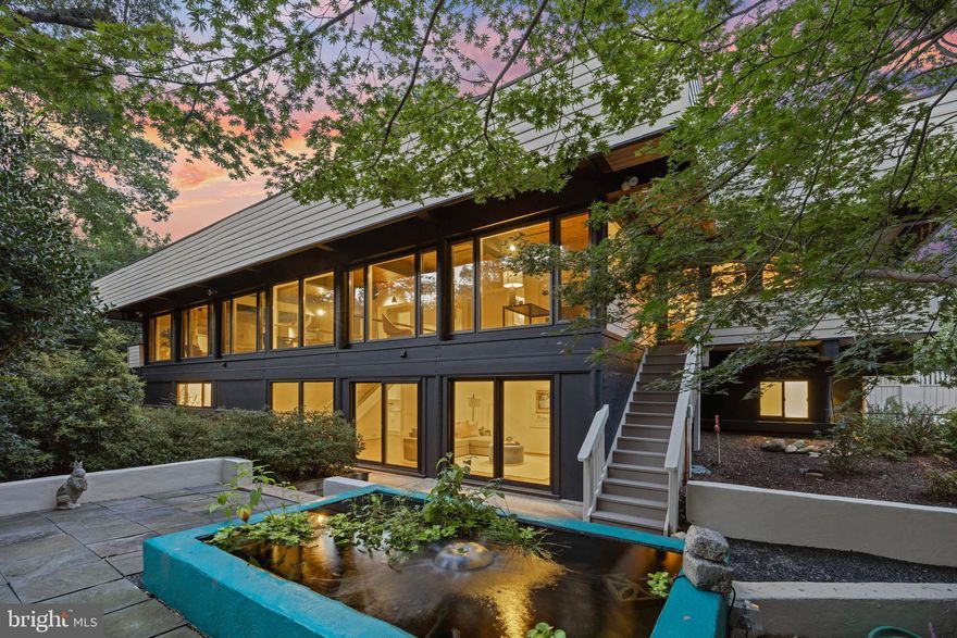 Sited on the most coveted street along the George Washington Parkway is this custom Mid Century Modern retreat with seasonal Potomac River Views.  This European inspired residence offers a private serene environment on a 1/2 acre treed lot and is only 20 minutes to Washington DC.  This custom home boasts of almost 4500 finished sq ft, an elevator, 3+ bedrooms, 3.5 baths, and an oversized 2-car garage.   Over 1200 sq ft of porches with calming views and entertainment areas of patios and private decks.  The architectural features converge with nature in this inspiring home so close to the nation's capitol.
Custom built with concrete and hardiplank construction enduring post and beam design. The soaring ceilings and expansive windows illuminate the space, bringing the outside within.  Enjoy running and biking along the Mount Vernon Trail to Old Town or George Washington's Estate. 
This unique home is designed for individuals seeking something out of the ordinary and those who appreciate their surroundings. It's a space where the creative mind can truly flourish and explore.