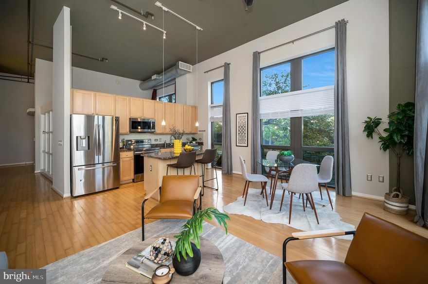 Embrace the epitome of luxury living at the heart of the vibrant Shirlington Village. Dive into the sophistication of #112 at Shirlington Village Condo – a one-bedroom, loft-style sanctuary that effortlessly captivates. Bathed in light from the towering 10’ windows, the space boasts an urban industrial charm with its 13’ ceilings, exposed ductwork, and pipework.  Anchoring the living space is an elegant open-concept kitchen; adorned with an island, maple cabinets, stainless steel appliances, and gleaming granite countertops. This living expanse is complemented by warm hardwood floors throughout. The generously-sized bedroom doesn't fall short – showcasing tall ceilings, a spacious walk-in closet, and a connecting bathroom.  Every convenience has been thought of – from the in-unit full-size washer and dryer to your very own reserved parking in the garage, not forgetting the additional storage space.  Beyond the walls of your condo, the Shirlington Village Condo complex unfolds a myriad of amenities: secure entry, a welcoming concierge, stylish communal areas, a TV lounge, library, fitness room, an inviting outdoor pool, and a serene courtyard.  Stepping out, the Village of Shirlington awaits your exploration. Revel in its rich tapestry of theaters, eateries, boutiques, and every essential convenience – even a grocery store right at your doorstep. For nature enthusiasts, the nearby W&OD trail winds by the scenic Four Mile Run Stream and leads to the inviting Shirlington Dog Park.  And when the outside world calls, you're strategically positioned with easy access to RT 395, connecting you seamlessly to the heartbeats of Arlington, Washington, DC, and Alexandria. Condos in this coveted building are a rarity, a testament to its allure. Here lies a golden chance to seize the lifestyle you've always envisioned.