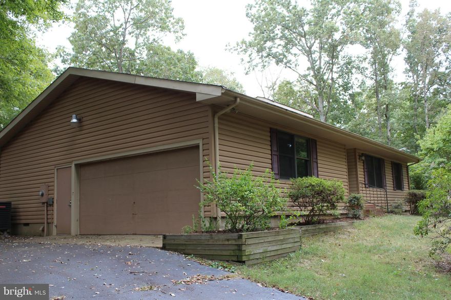 Move in ready!   Country living close to town! 3 bedroom/ 2 bath rambler located off route 3, minutes from 95, Central Park & much more!  Features kitchen w/table space PLUS separate dining room.  Large living room with cathedral ceilings & fire place.  Beautiful wooded lot that back to farm.