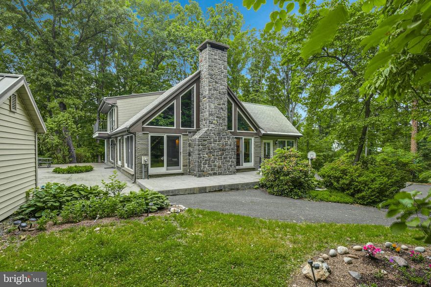 Set on a sheltered hillside, this serene property is approached from a private drive and rests on 45 idyllic acres. Natural woodlands, sunlit clearings, and an extraordinary residence comprise this distinctive venue unparalleled for its serenity and beauty. 

Architecturally designed to capture the essence of its vistas and surroundings, the home is a refreshing blend of tradition and modern finishes. Multiple levels of finished living space are enhanced with hardwood floors, vaulted ceilings, and abundant windows for views of the pool and the hillside beyond. The expansive kitchen with large island opens to a dining room for easy entertaining. The primary bedroom on this level offers another wood-burning fireplace for cozy evenings. A half bath and additional bedroom round out this floor. The loft suite is a luxurious hideaway with a balcony for meditation and bird’s eye views of the changing seasons. The finished lower level includes a recreation room, family room, additional bedroom, and full bath.

A large stamped concrete patio surrounds the inground pool, perfectly placed for warm afternoons or an evening swim beneath the stars. Swift arrival to I-78, schools and shopping, and Easton’s burgeoning restaurant scene and city center add to the appeal of this uniquely impressive property.