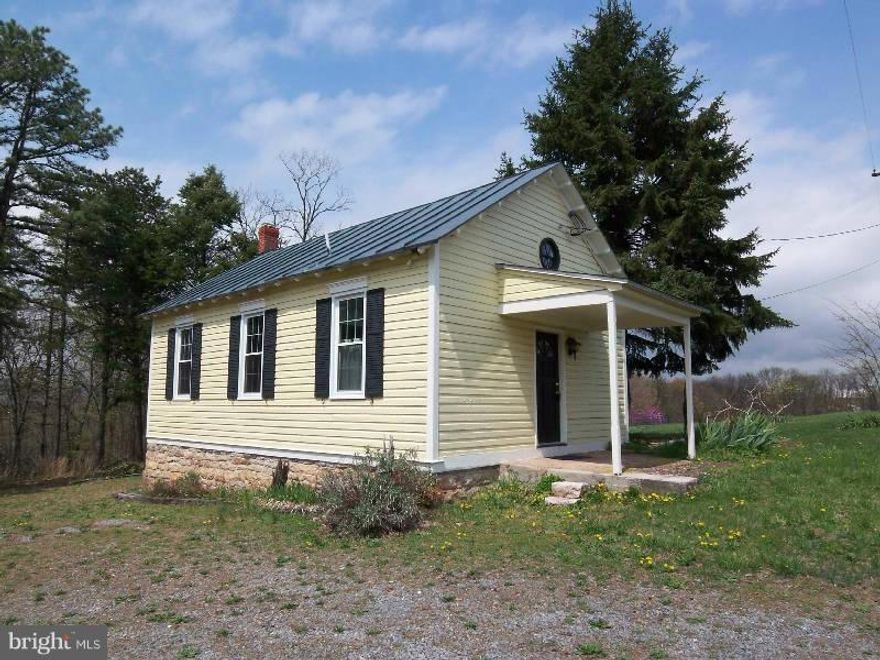OWN A PIECE OF HISTORY Built as a 1-Room School House in 1904.  Modified to be used as a residence, but the charm remains, along with the old chalk boards.  640 sq. ft. w/ additional space in the loft.  Fronts paved county road and situated on 23.3 UNRESTRICTED acres.  New well and  4 BR septic installed.  Mixture of field and wooded.   Updated Kitchen and bathroom.